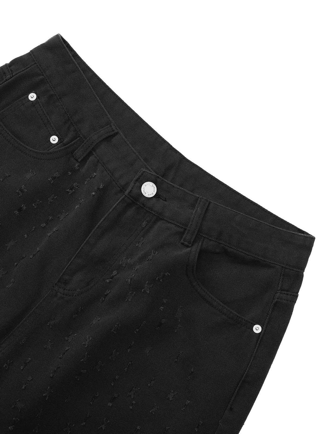 A tight crop highlighting the textured design of black denim shorts by TALISHKO.
