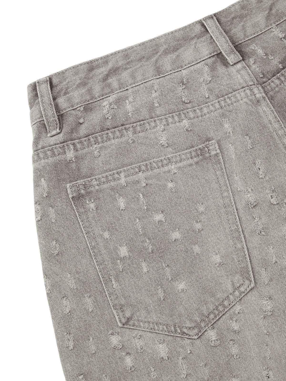 Intricate look at gray denim shorts by TALISHKO, showcasing a textured and ripped design.