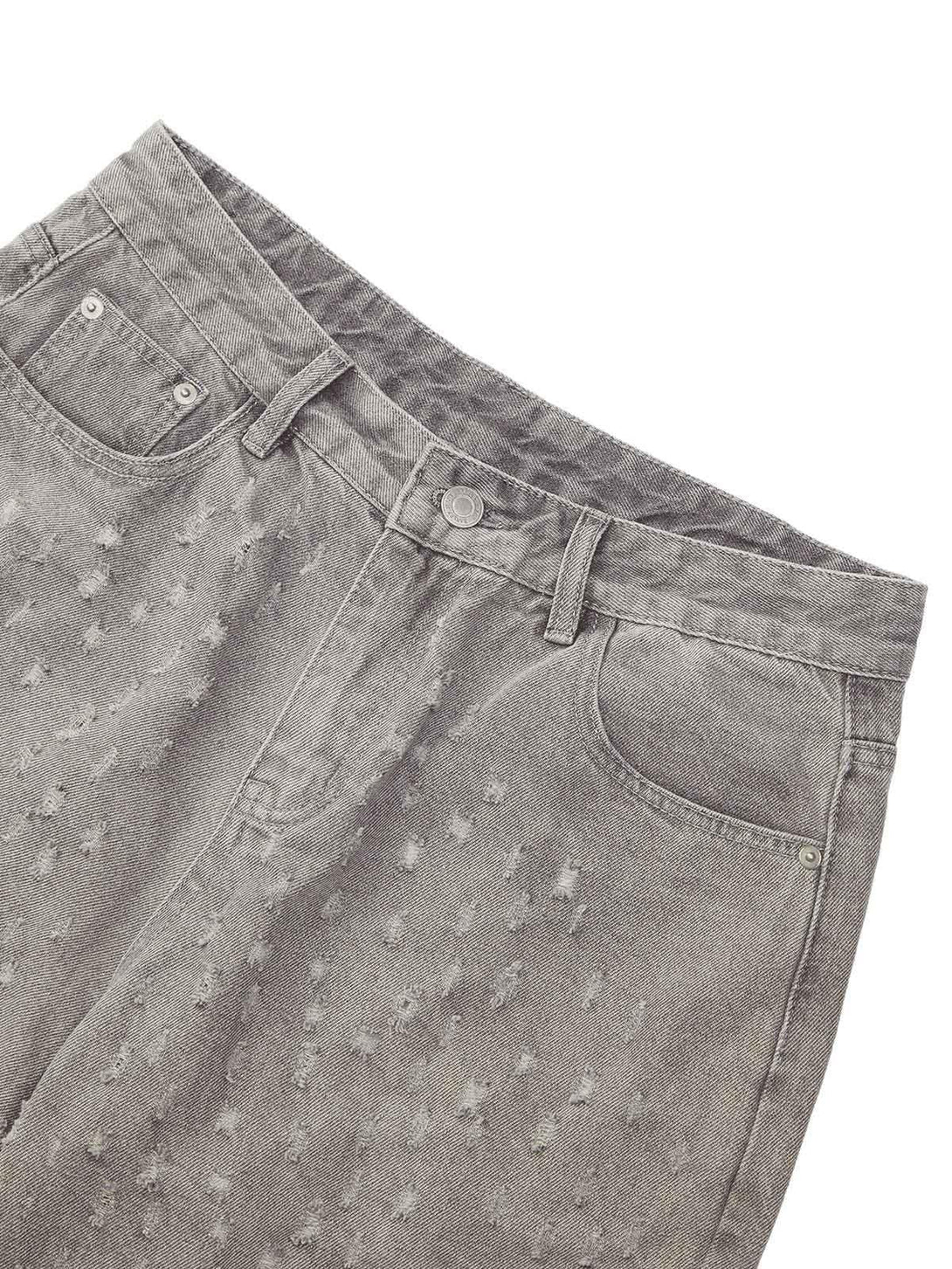 A detailed view of gray ripped denim shorts by TALISHKO, highlighting textured design.
