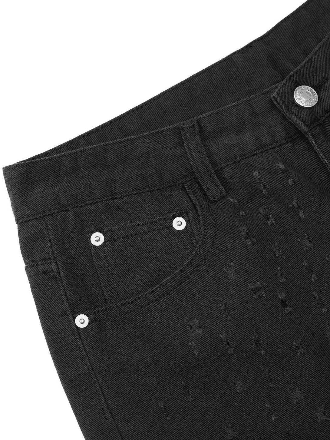 A detailed view of black denim shorts by TALISHKO, highlighting unique ripped texture.