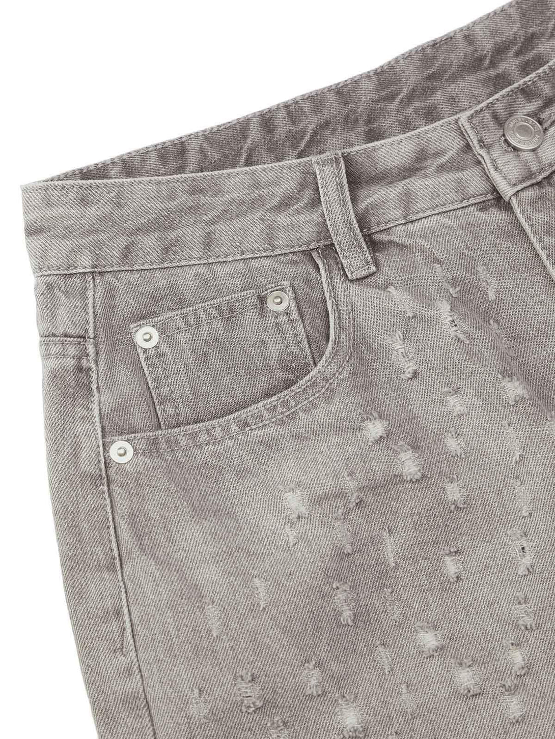 Detailed fabric and stitching of ripped denim shorts by TALISHKO, highlighting niche design.