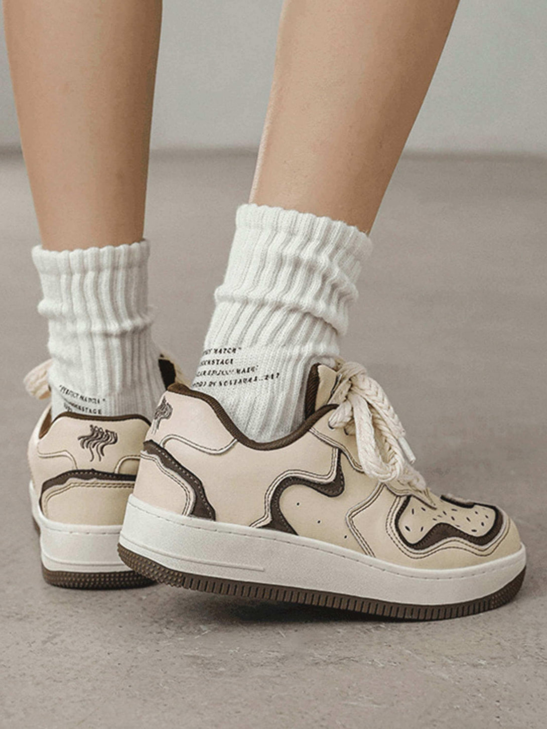 TALISHKO skateboard shoes in beige and brown with thick laces, styled with cozy white socks.