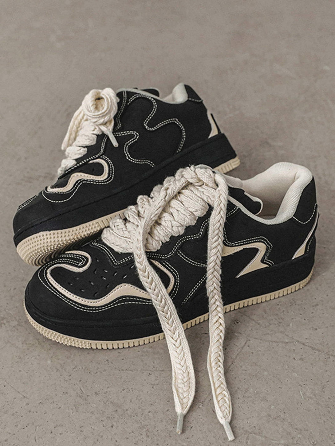 TALISHKO skateboard shoes in black with bold stitching and chunky laces, ideal for urban fashion.