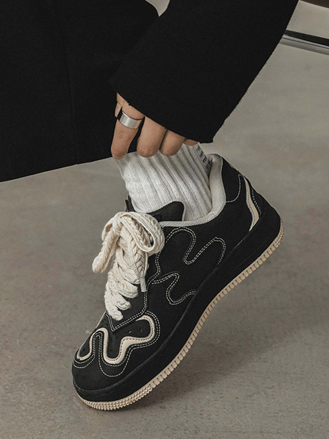 TALISHKO skateboard shoes in black with intricate stitching and chunky laces, ideal for trendy looks.