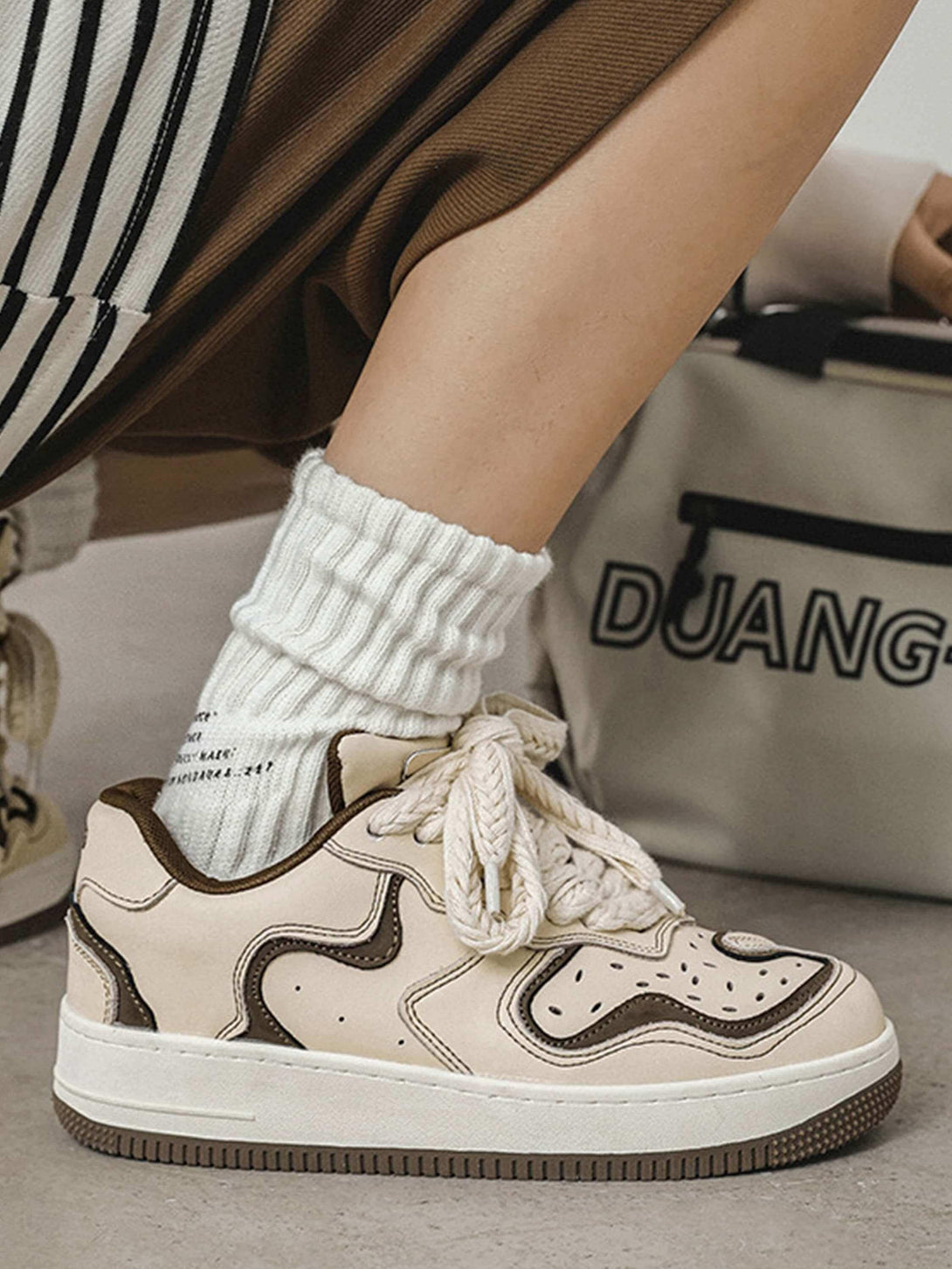 TALISHKO skateboard shoes in beige with unique detailing and thick laces, paired with casual socks.