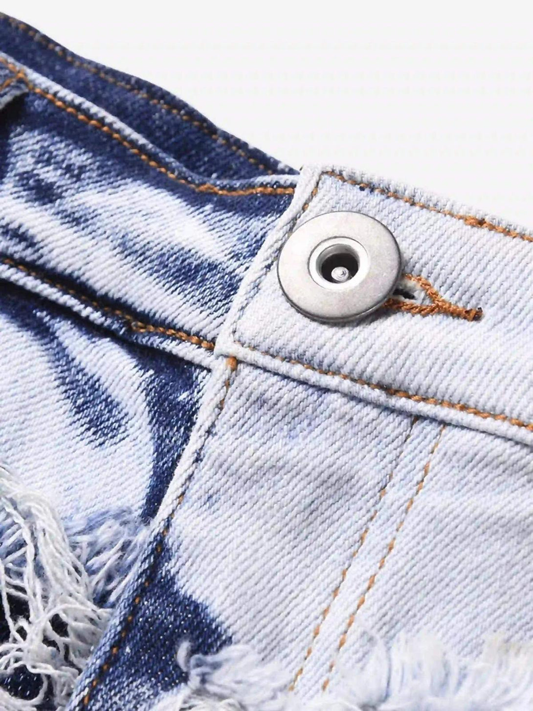 A close-up of TALISHKO's distressed denim, highlighting intricate stitching and rugged texture.