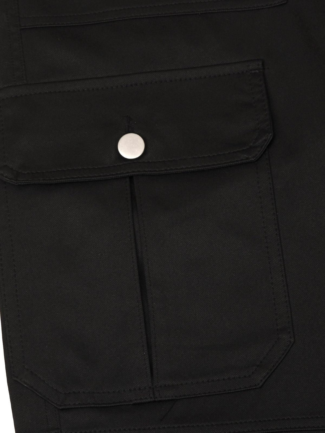 A close-up of the pocket detail on black cargo pants by TALISHKO, featuring a silver button.