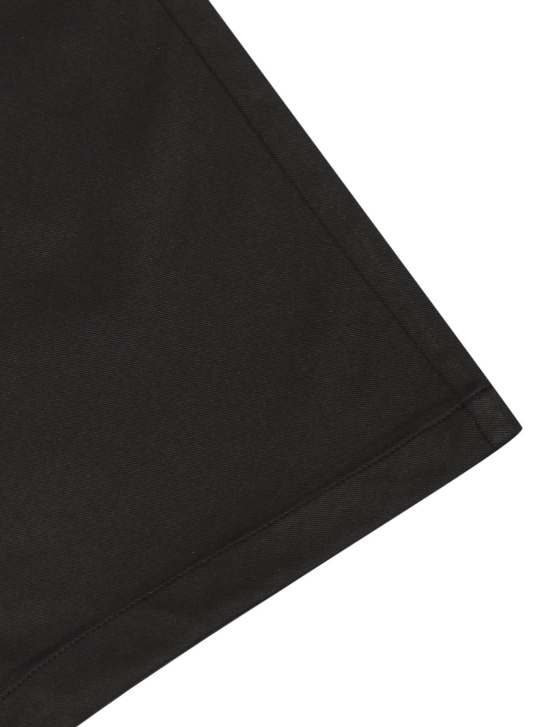 Detailed fabric and stitching of black cargo pants by TALISHKO, showcasing sleek craftsmanship.