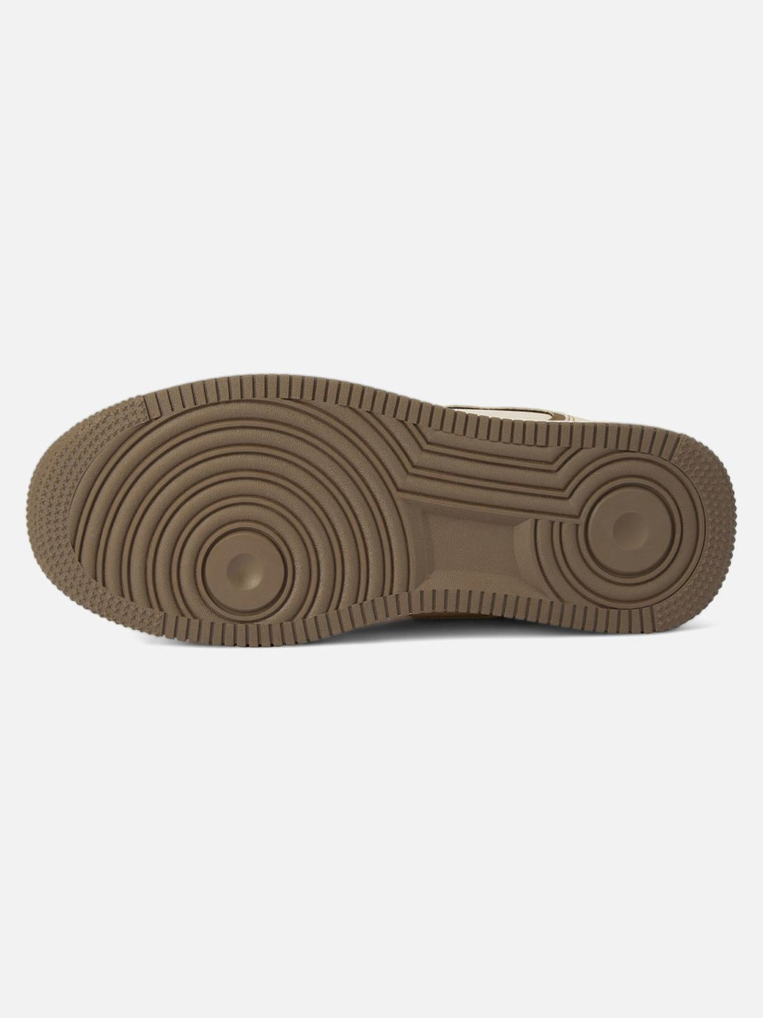 Brown sole design of TALISHKO skateboard shoes, highlighting circular traction pattern.