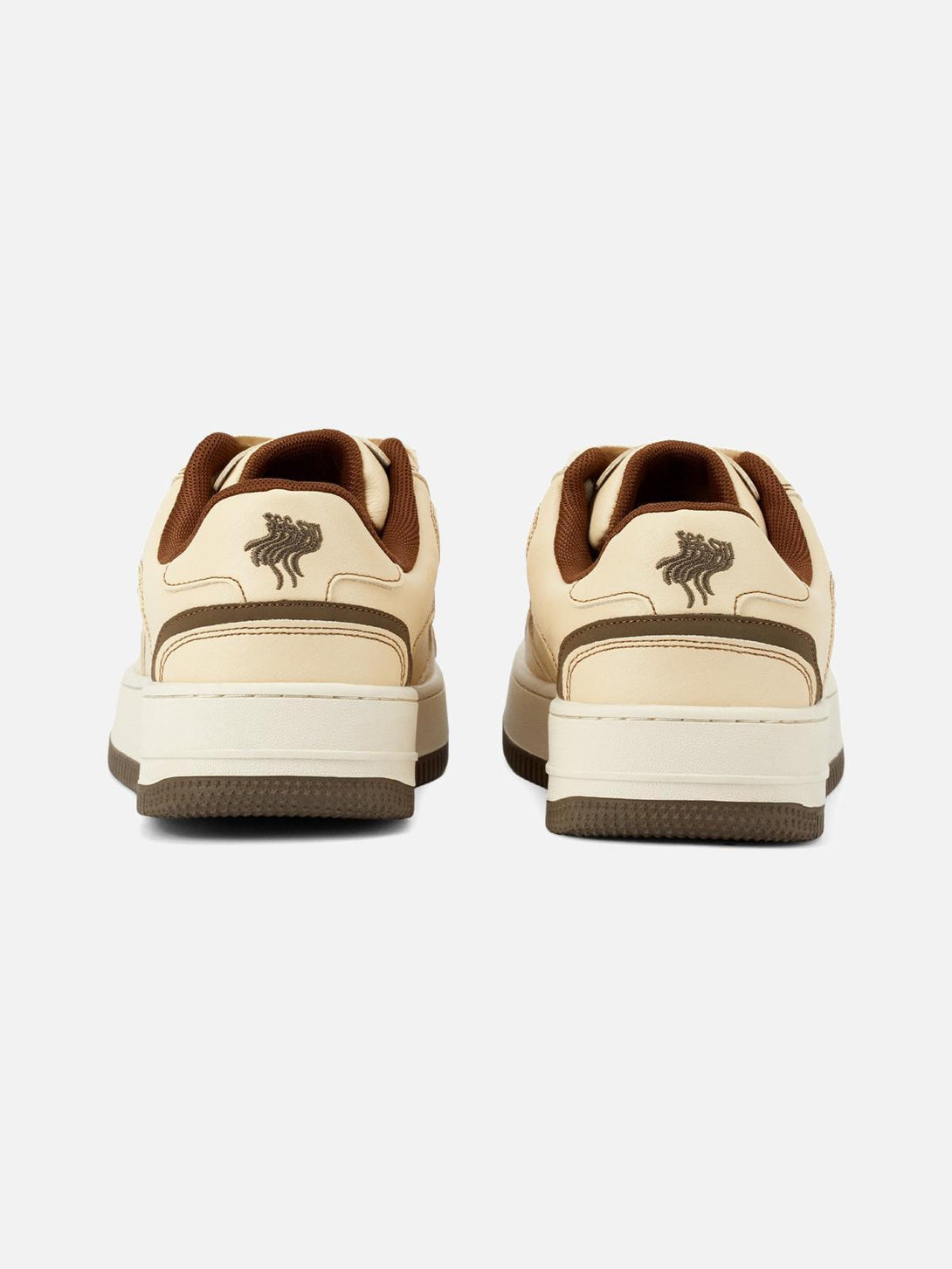 Back view of TALISHKO skateboard shoes in beige with brown accents and unique logo detail.