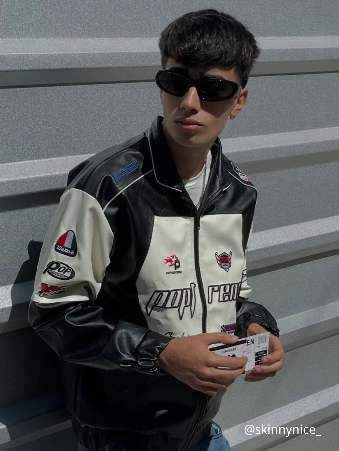 Model wearing a stylish racing baseball jacket by TALISHKO, featuring bold splicing accents.