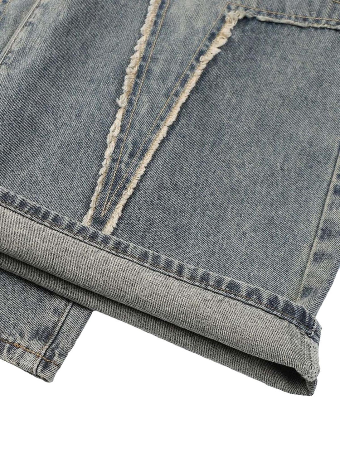 Detailed fabric and stitching of TALISHKO washed jeans, showcasing unique texture.
