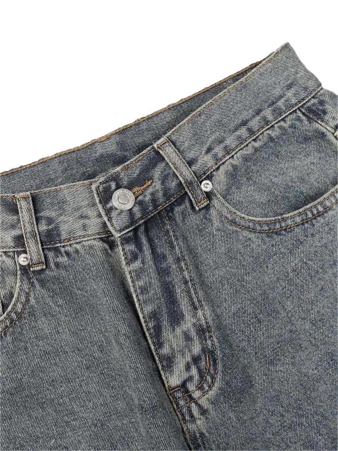 Detailed view of TALISHKO washed jeans, highlighting the texture and stitching on the front.