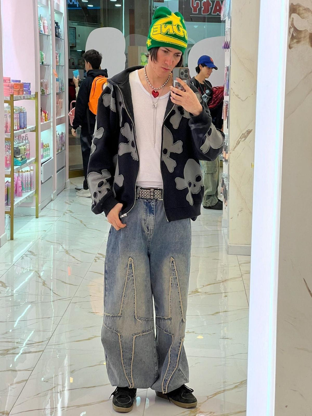 Model in TALISHKO streetwear, featuring star-patterned washed jeans with a relaxed fit.