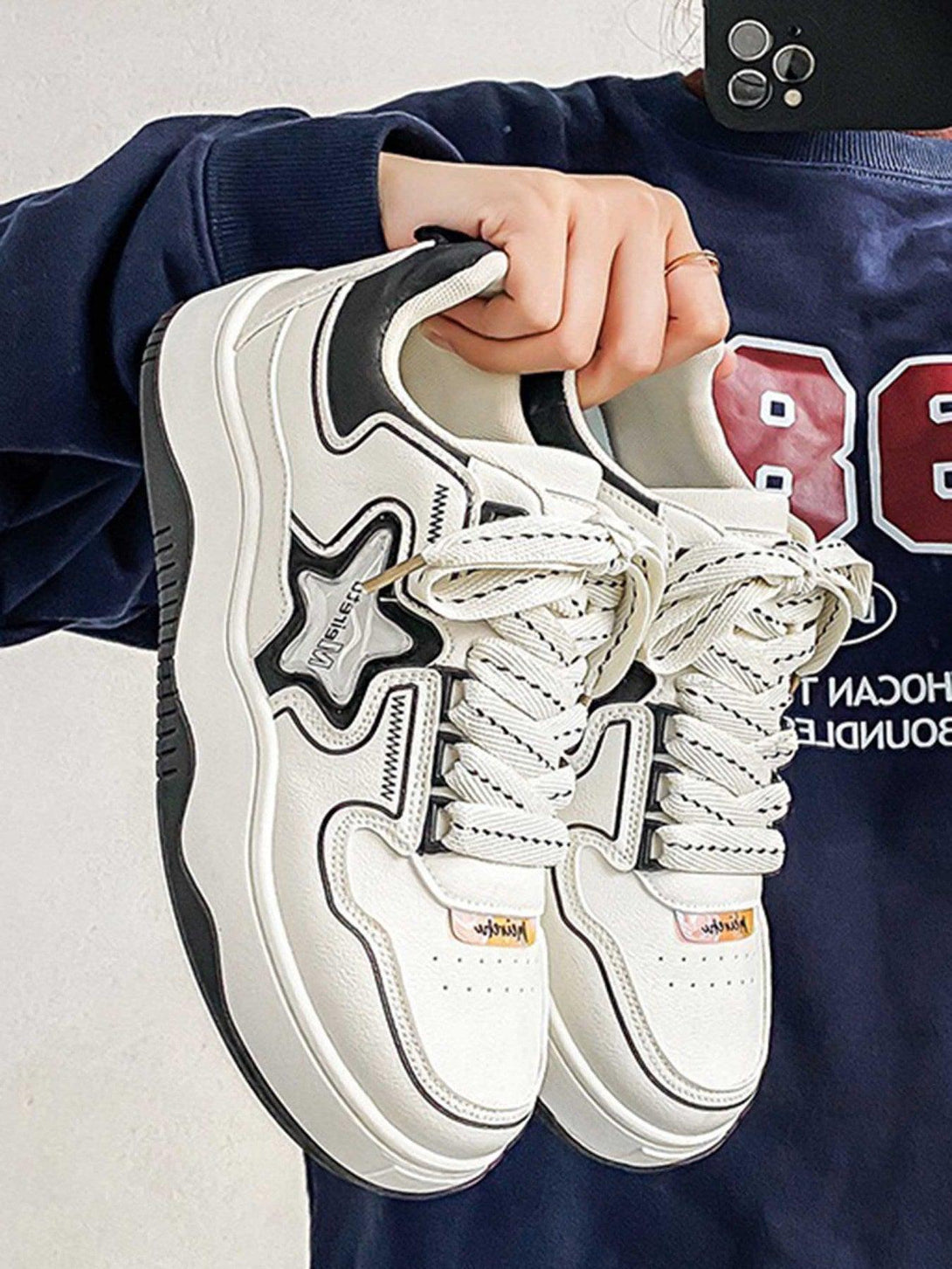 TALISHKO board shoes in white with a star design, featuring chunky soles and bold laces.