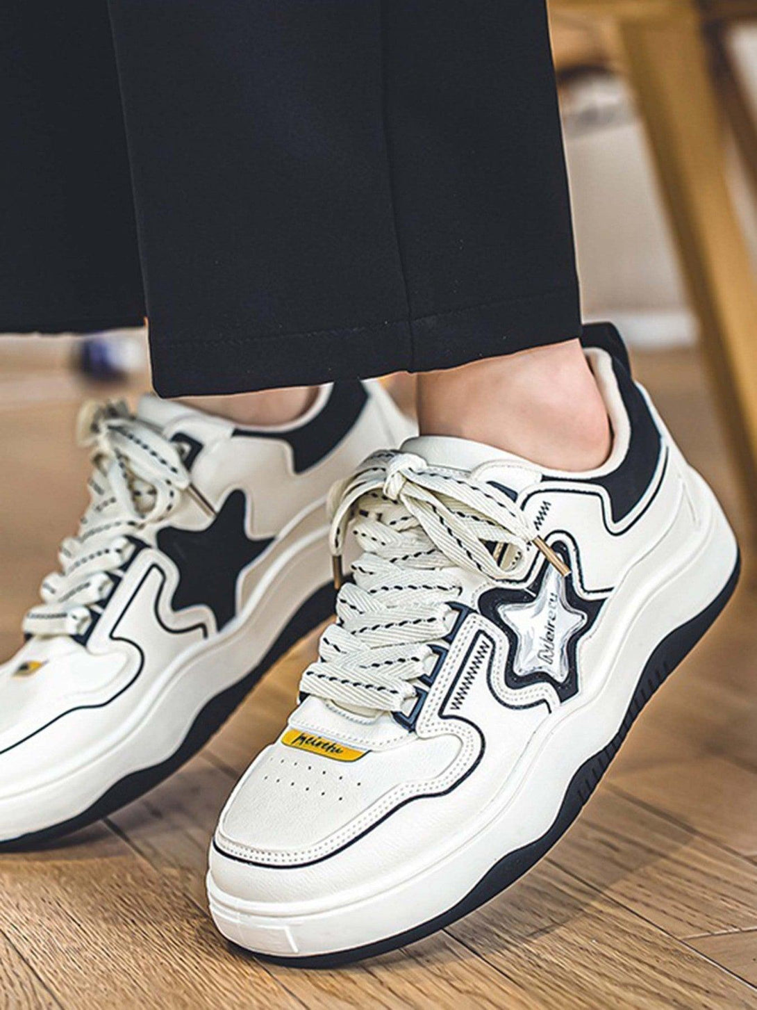 Sneakers by TALISHKO with bold star design and chunky sole, ideal for versatile street style.