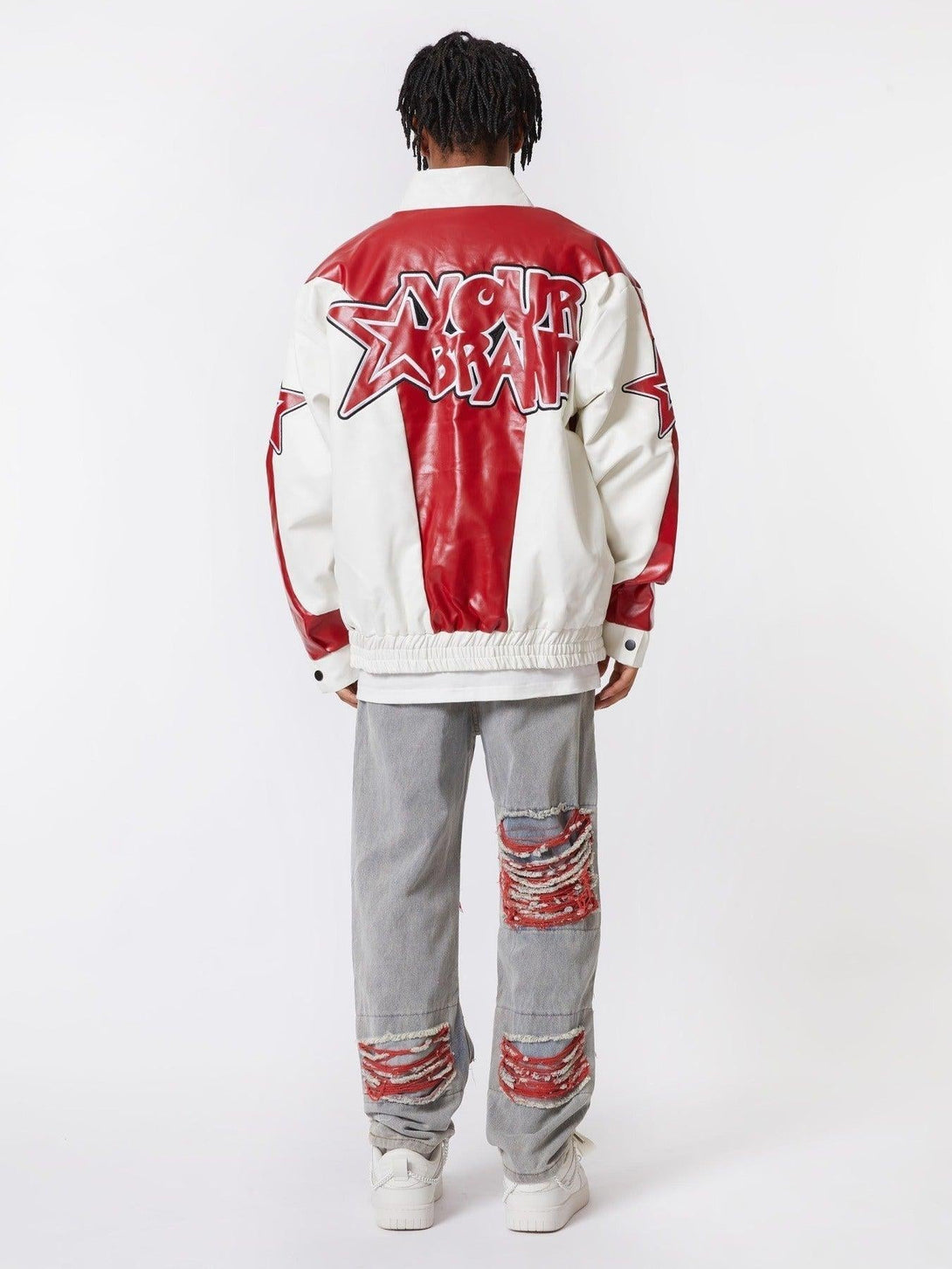 Back view of TALISHKO varsity jacket and distressed jeans with striking red accents.