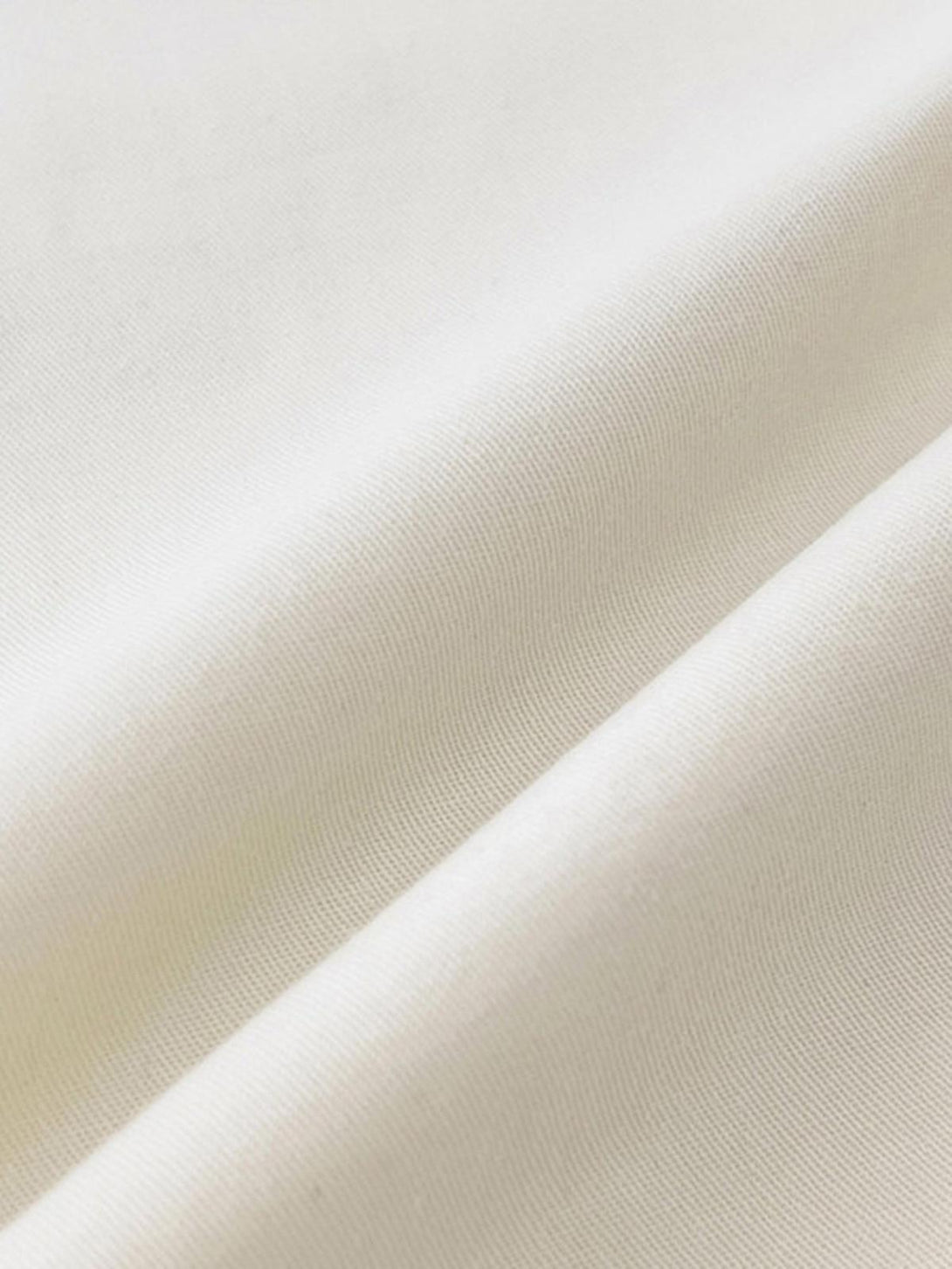 A close-up of TALISHKO's versatile short-sleeved shirt fabric, showcasing its smooth texture.