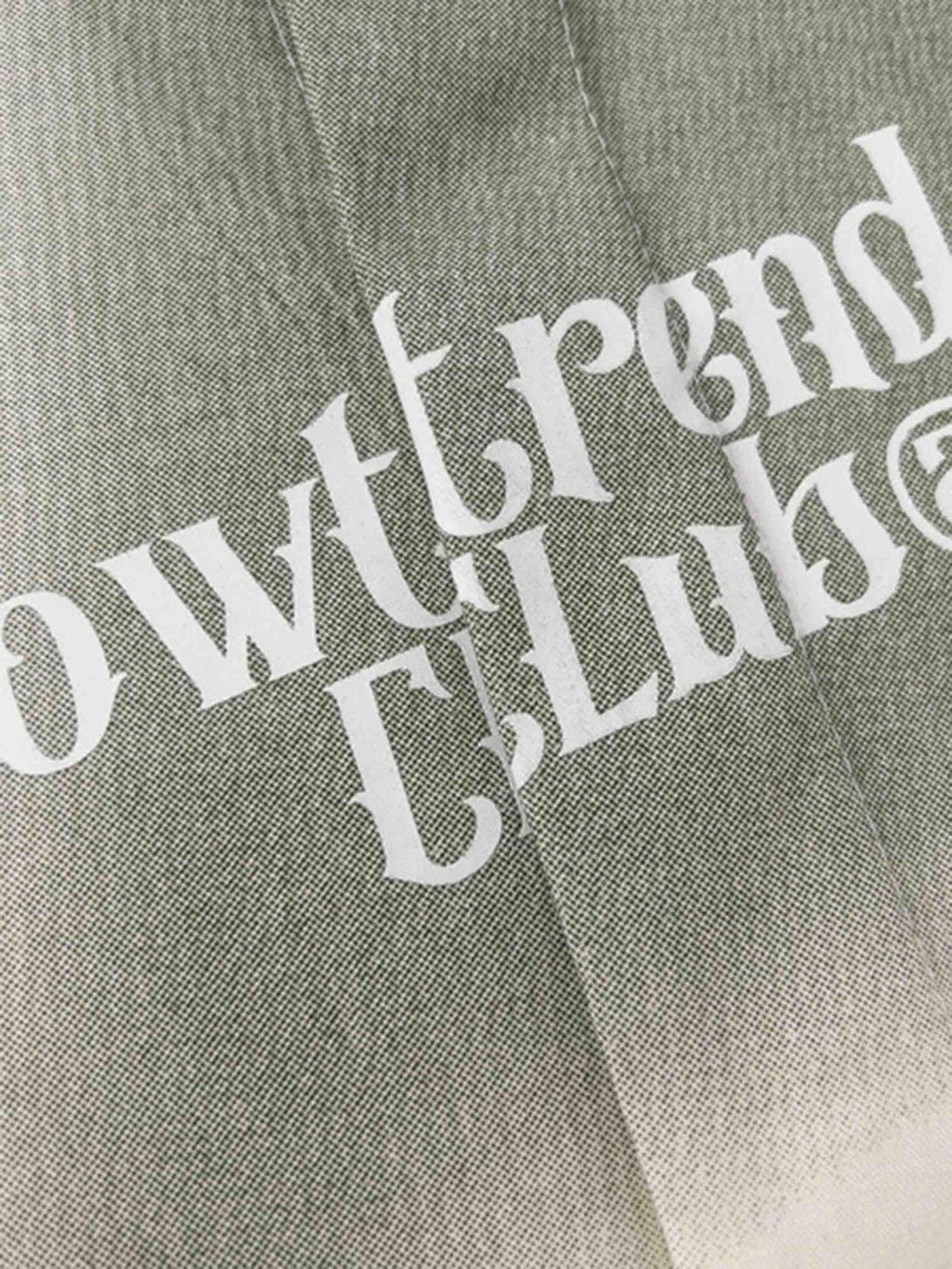 Zoomed-in texture of a TALISHKO short-sleeved shirt, highlighting intricate typography design.