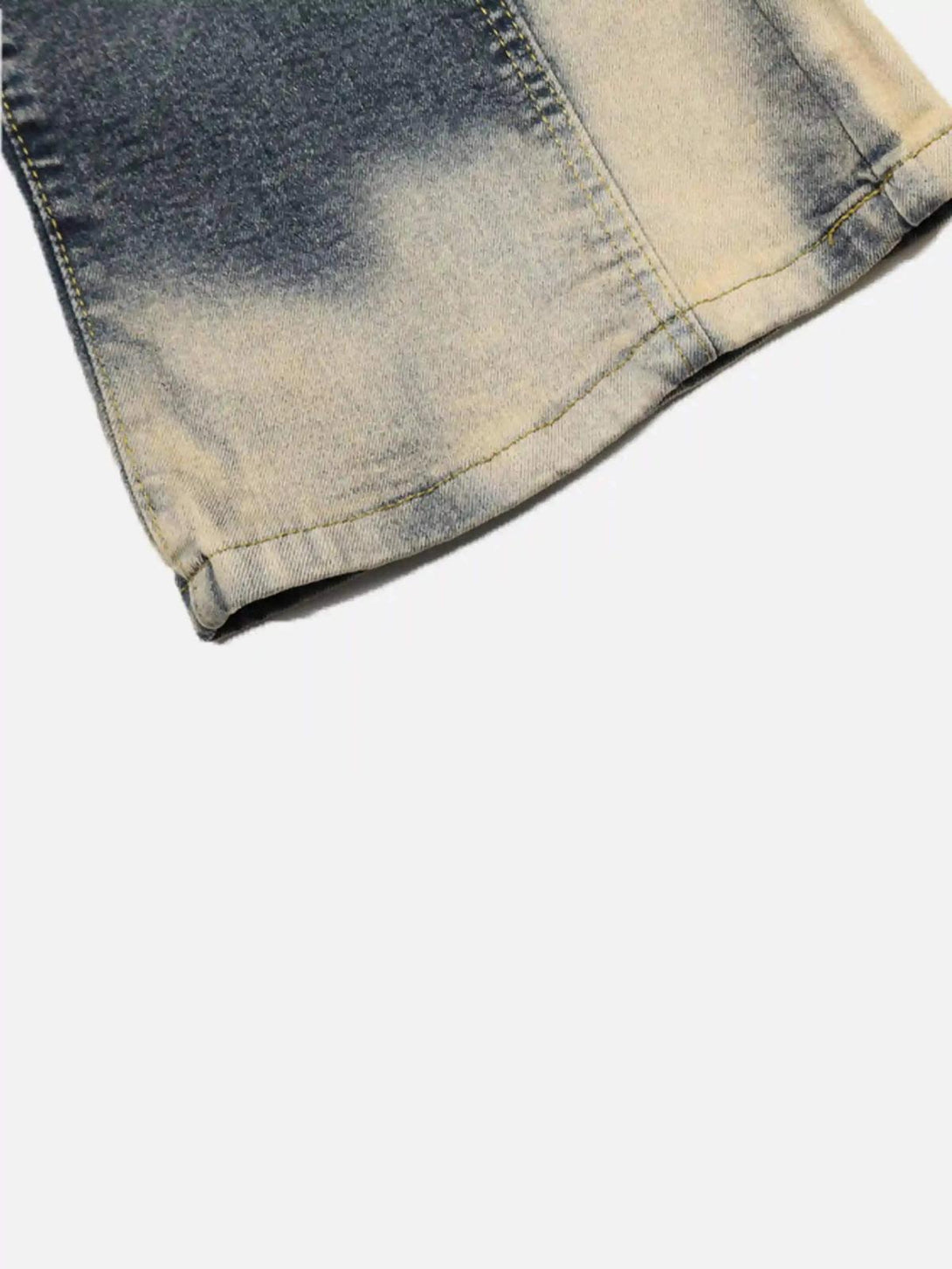 Close-up of TALISHKO flared jeans, highlighting the bleached hem and vintage denim texture.
