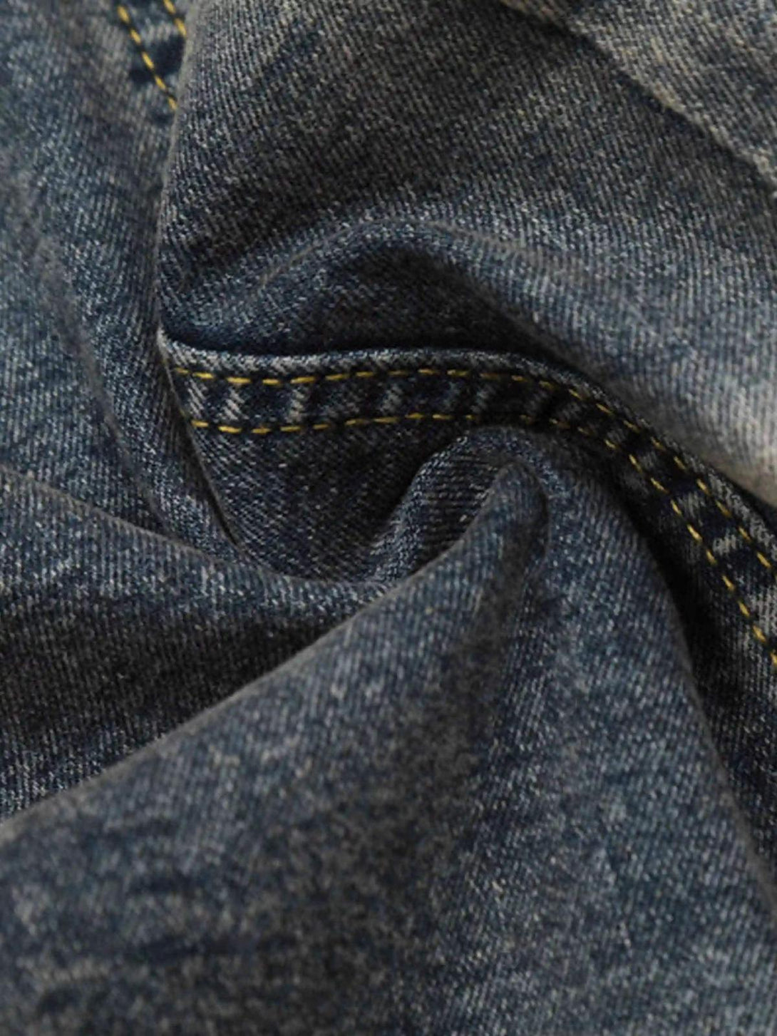 Texture and pattern showcased in TALISHKO vintage flared jeans, highlighting detailed stitching.