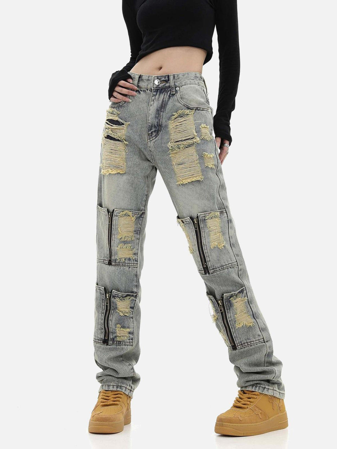 Model showcasing TALISHKO's washed denim pants with torn details and multiple work pockets.