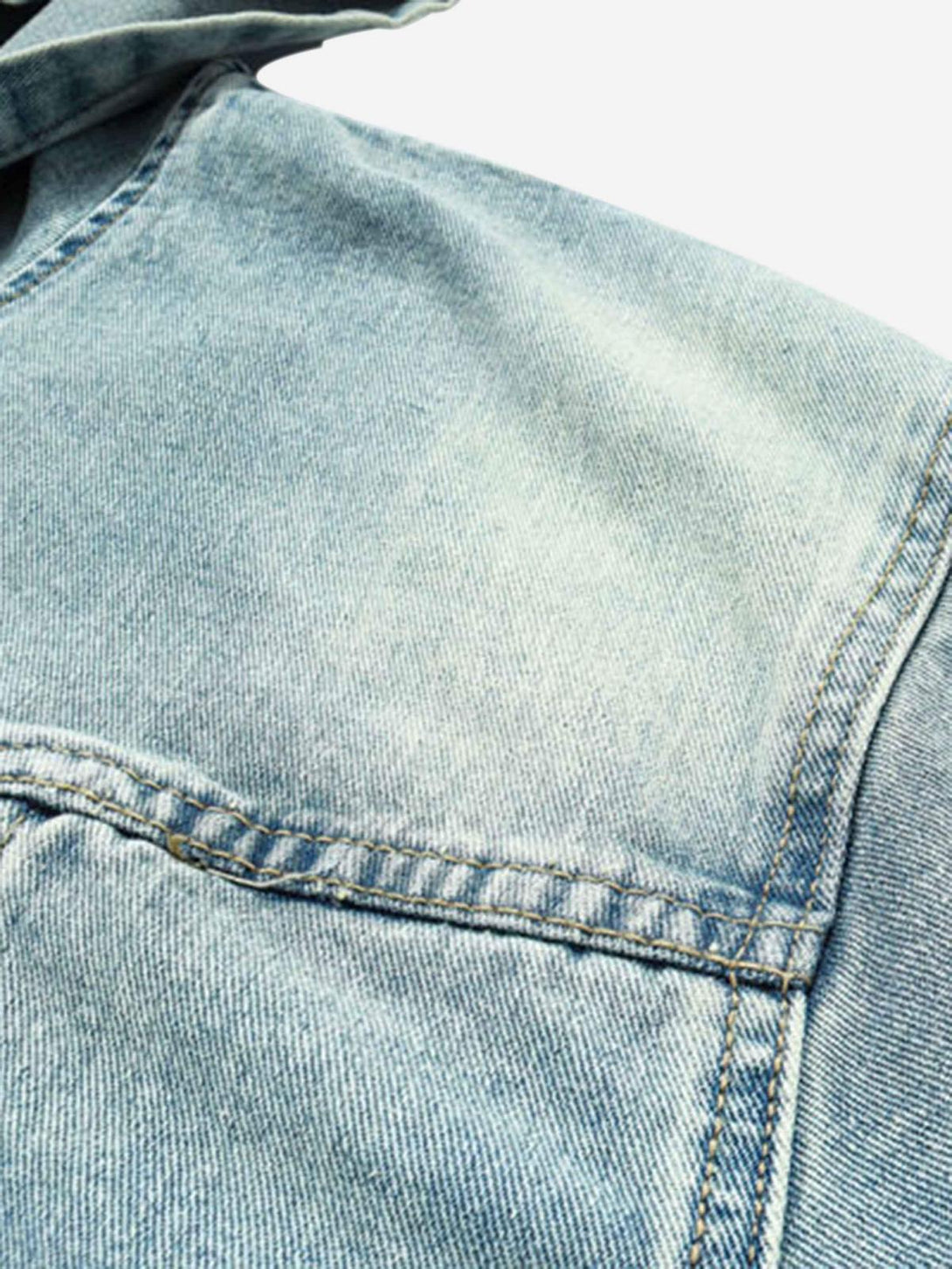 A detailed view of TALISHKO's washed denim hoodie, highlighting its unique texture.