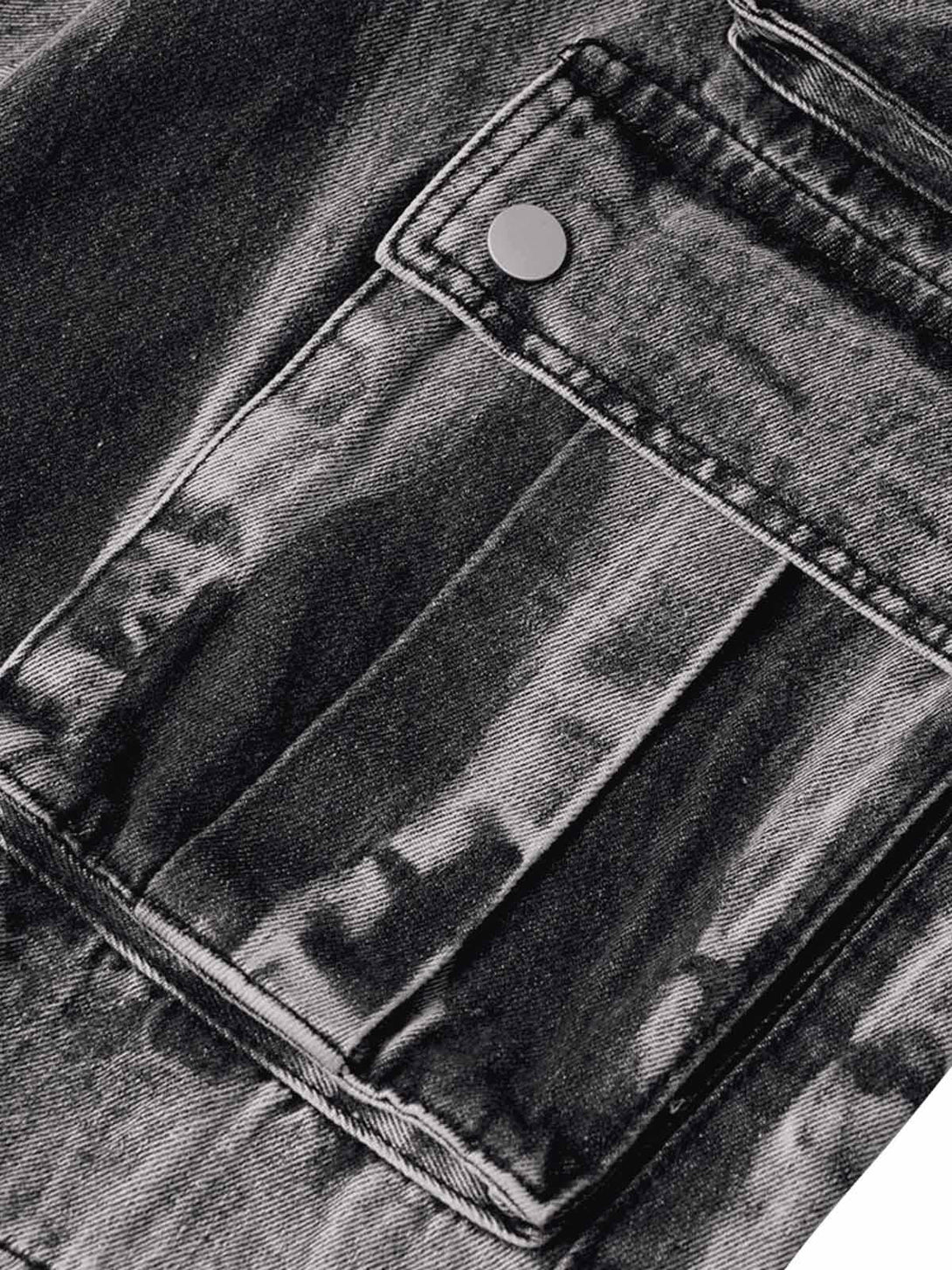 A tight crop highlighting the pocket detail on TALISHKO's washed distressed work jeans.