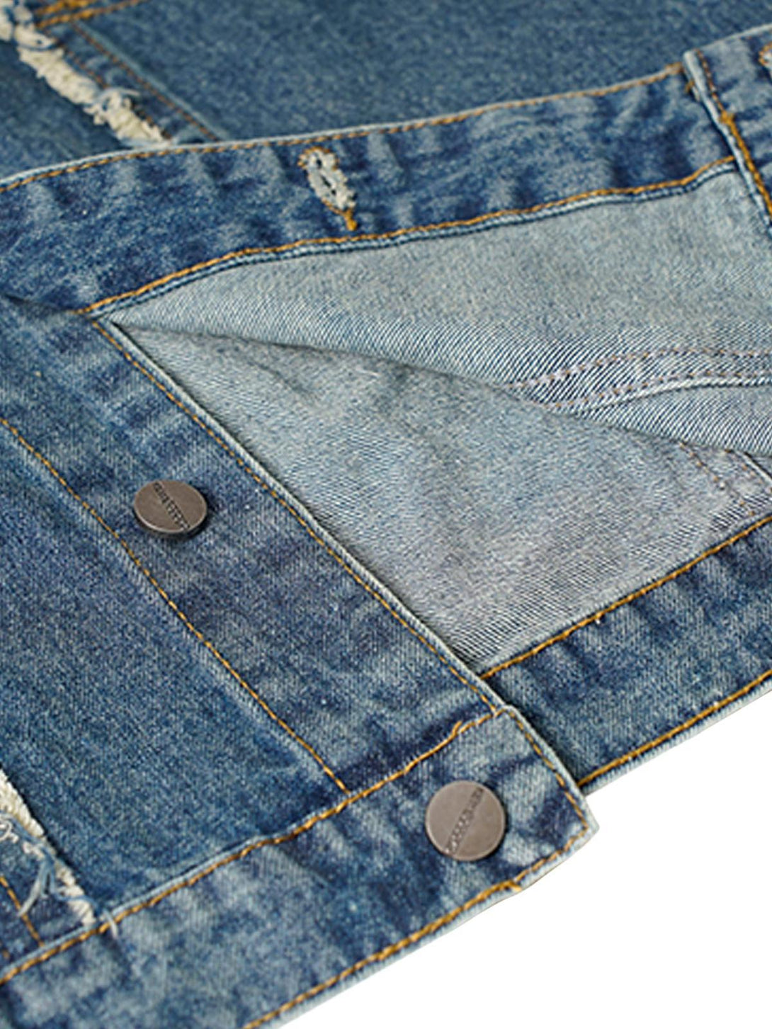 A close-up of the denim vest's raw edge and button details, highlighting TALISHKO craftsmanship.