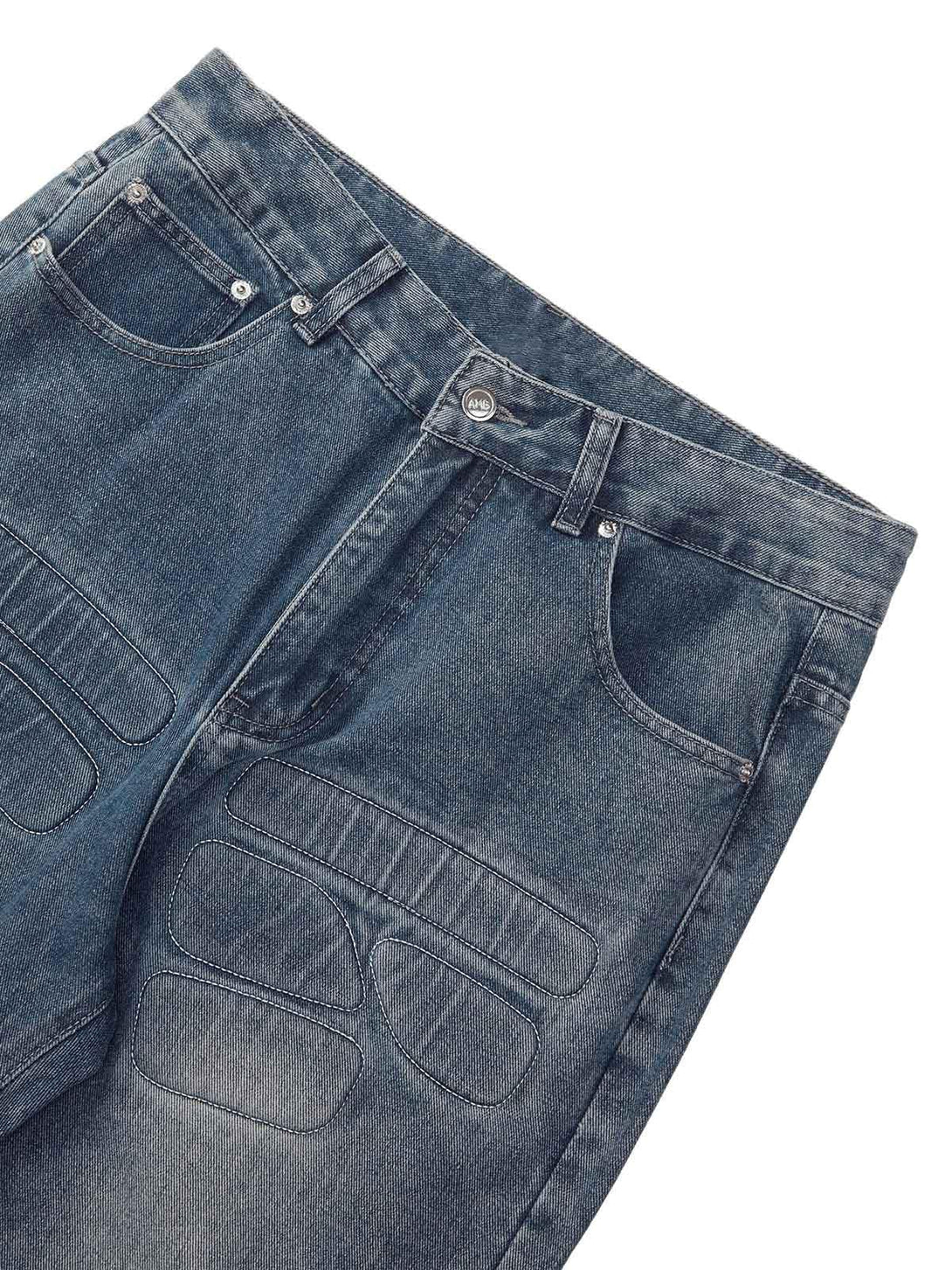 Detailed look at TALISHKO jeans, highlighting unique patchwork and washed texture.