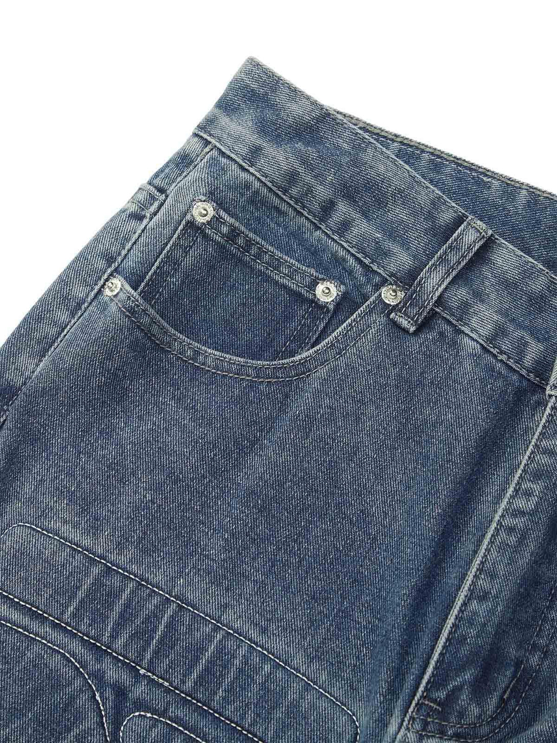 TALISHKO jeans close-up, showcasing intricate stitching and washed denim texture.