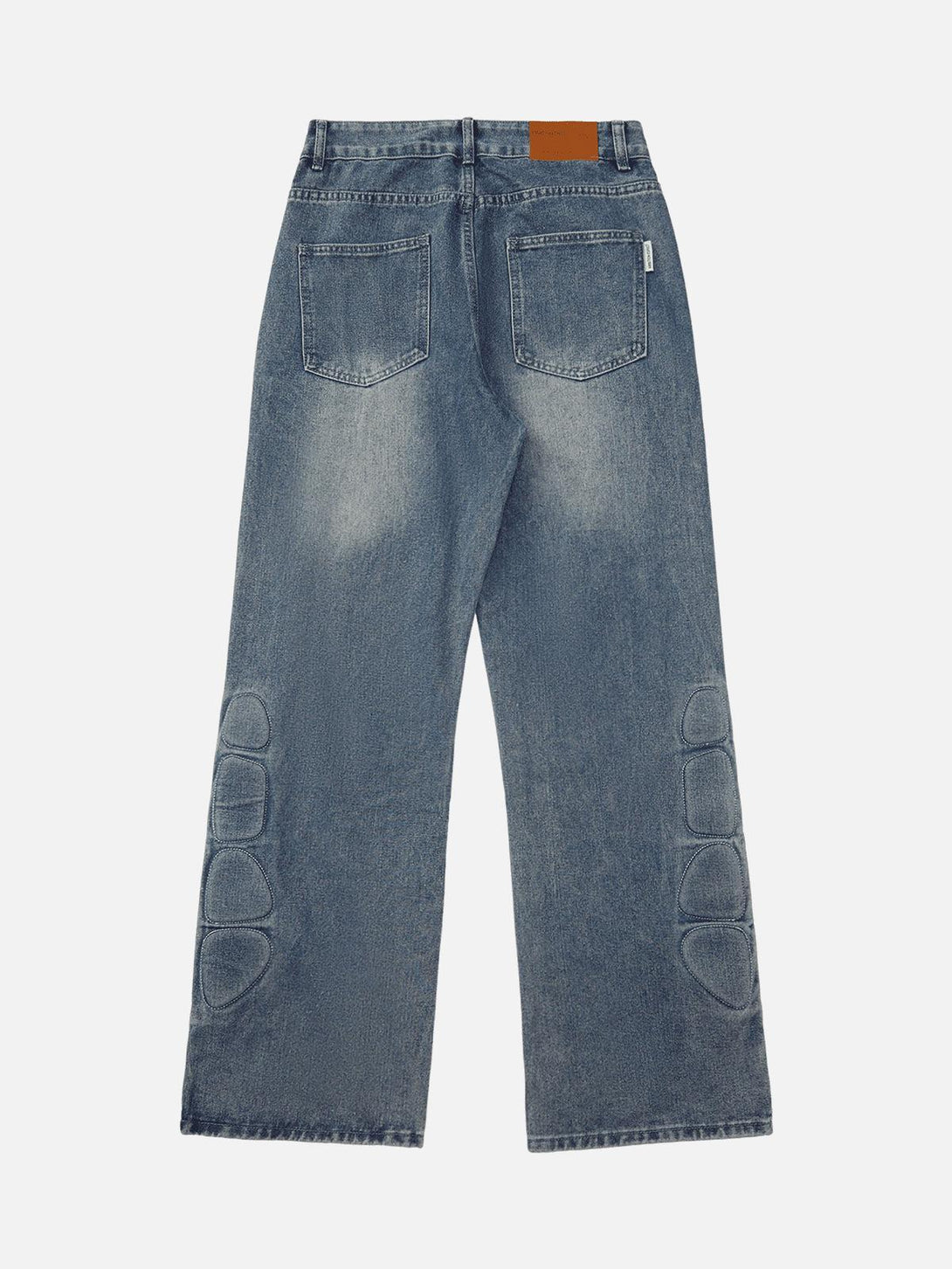 Back view of TALISHKO washed jeans, showcasing distinctive patch designs and classic pockets.