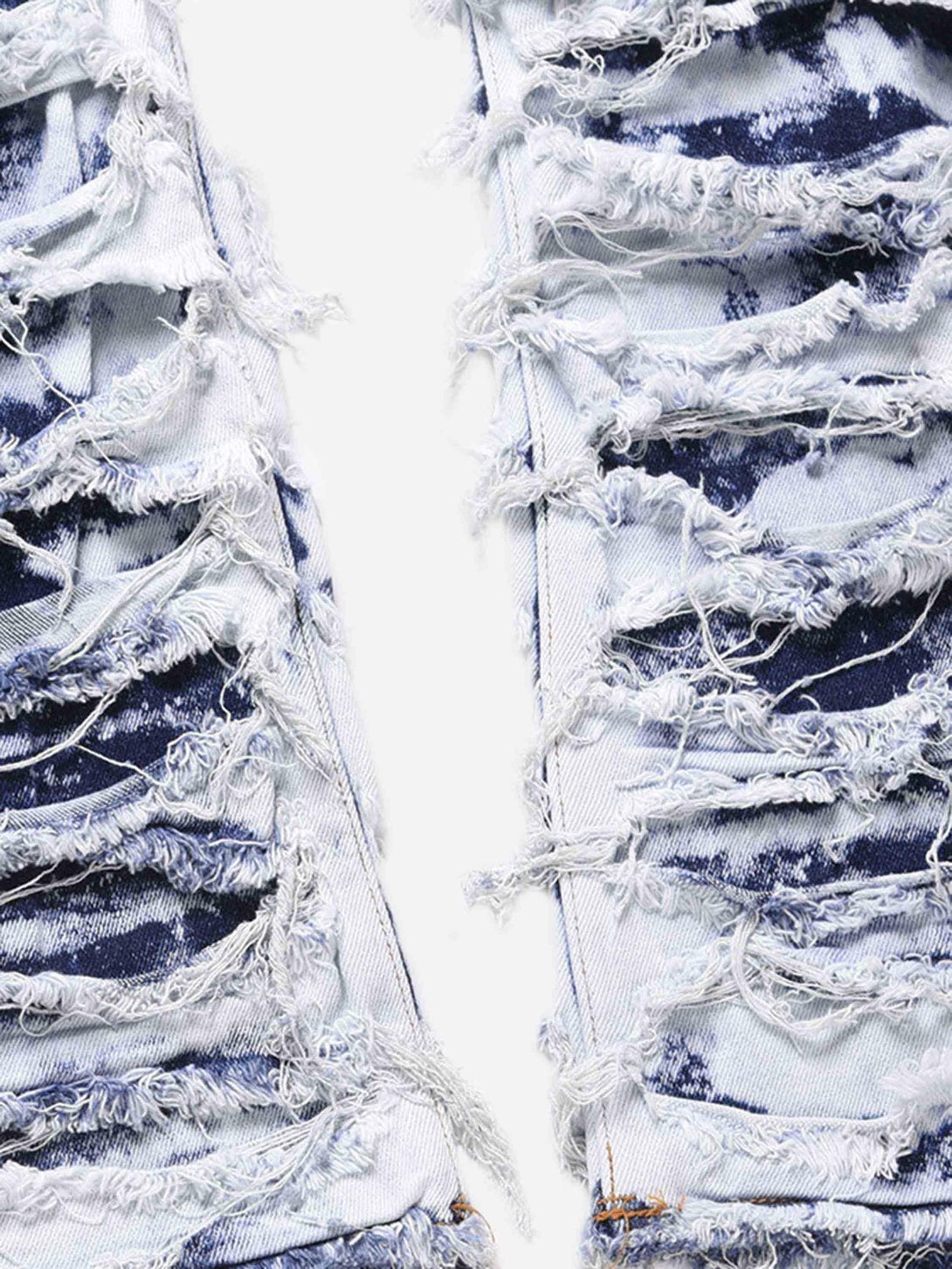 Frayed details and texture of TALISHKO high street washed slim fit jeans, showcasing bold style.