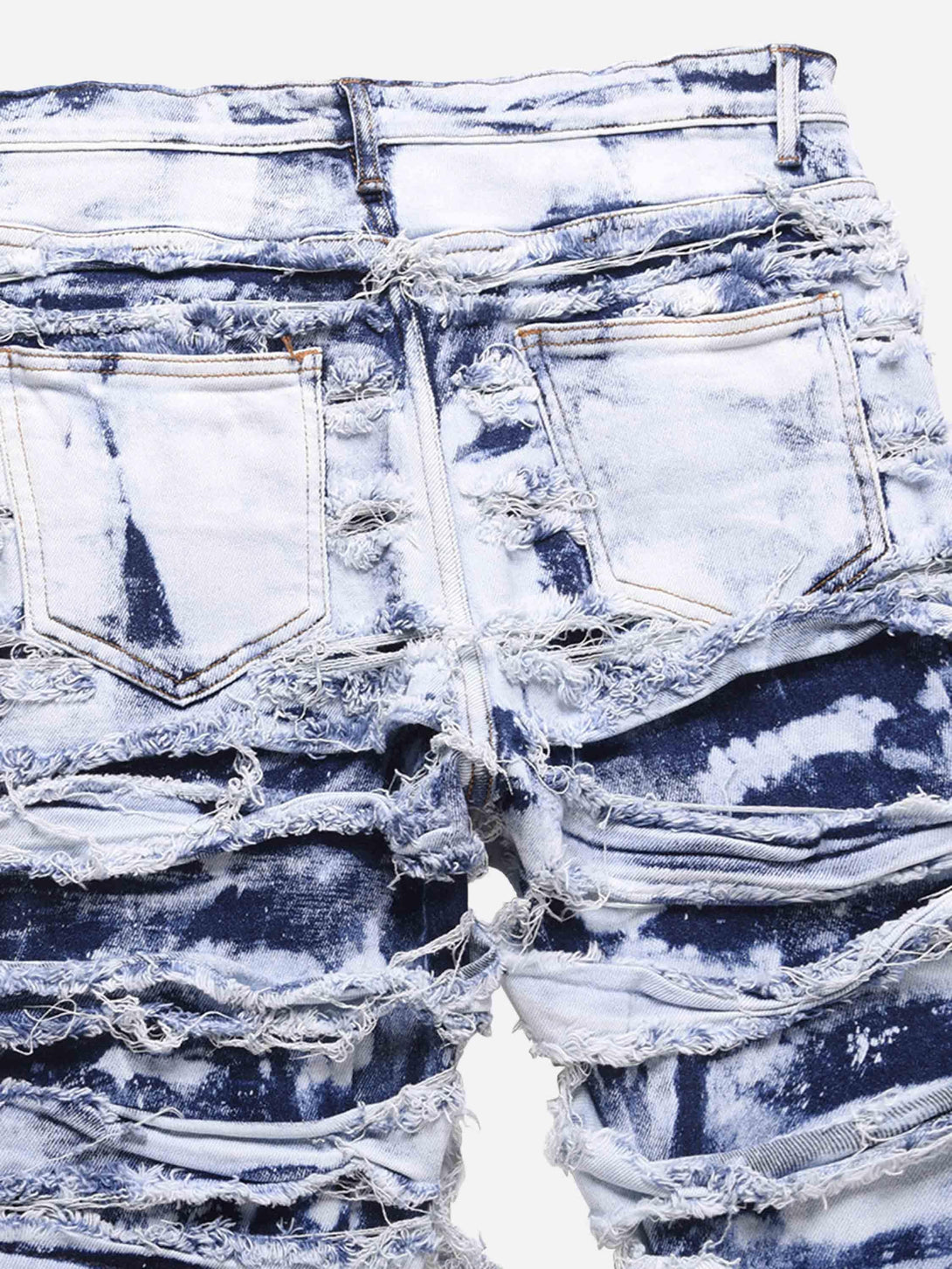 Back view of TALISHKO washed jeans, highlighting a bold distressed texture and design.