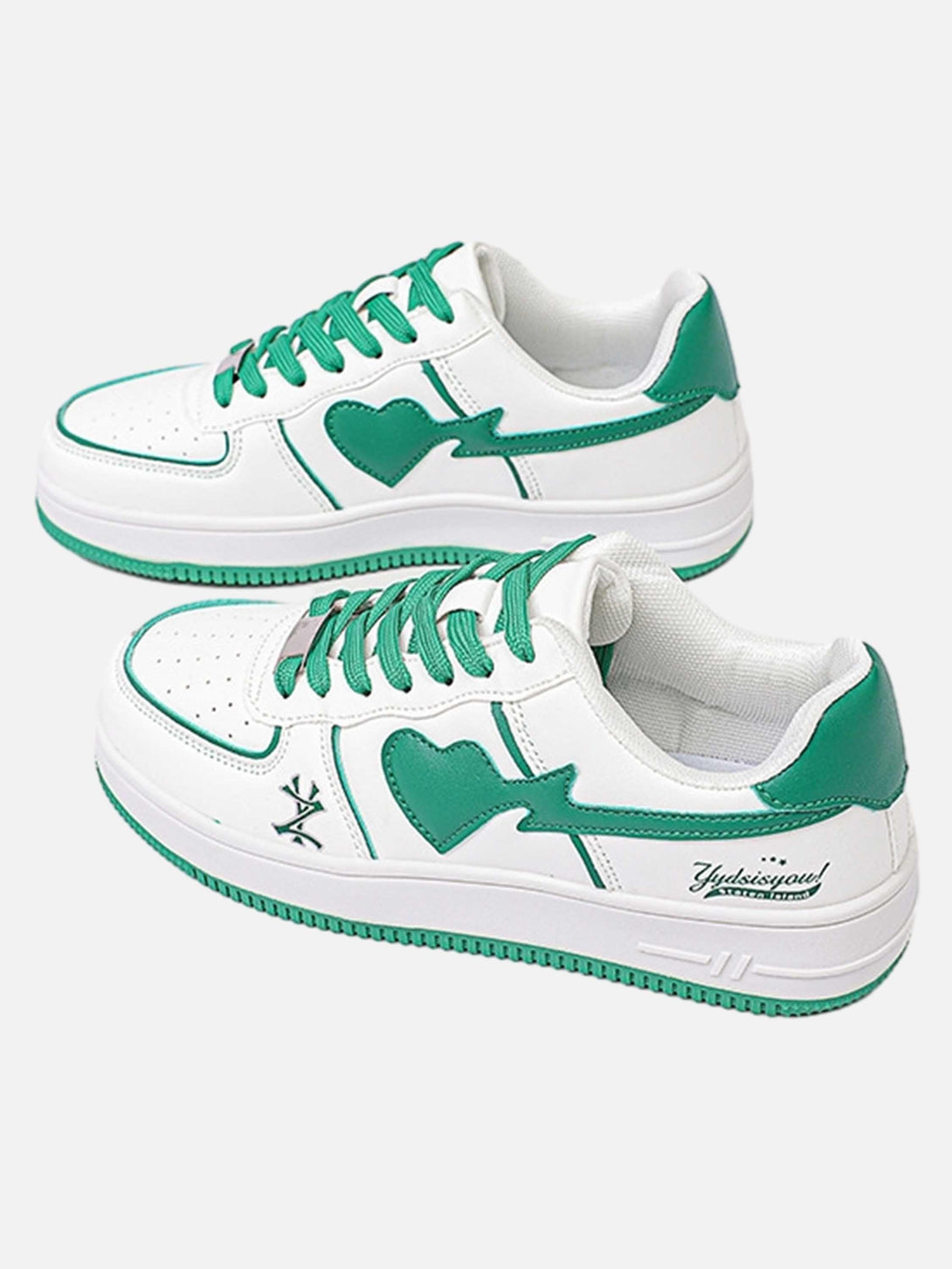 White skate sneakers with green heart accents by TALISHKO, featuring vibrant laces.