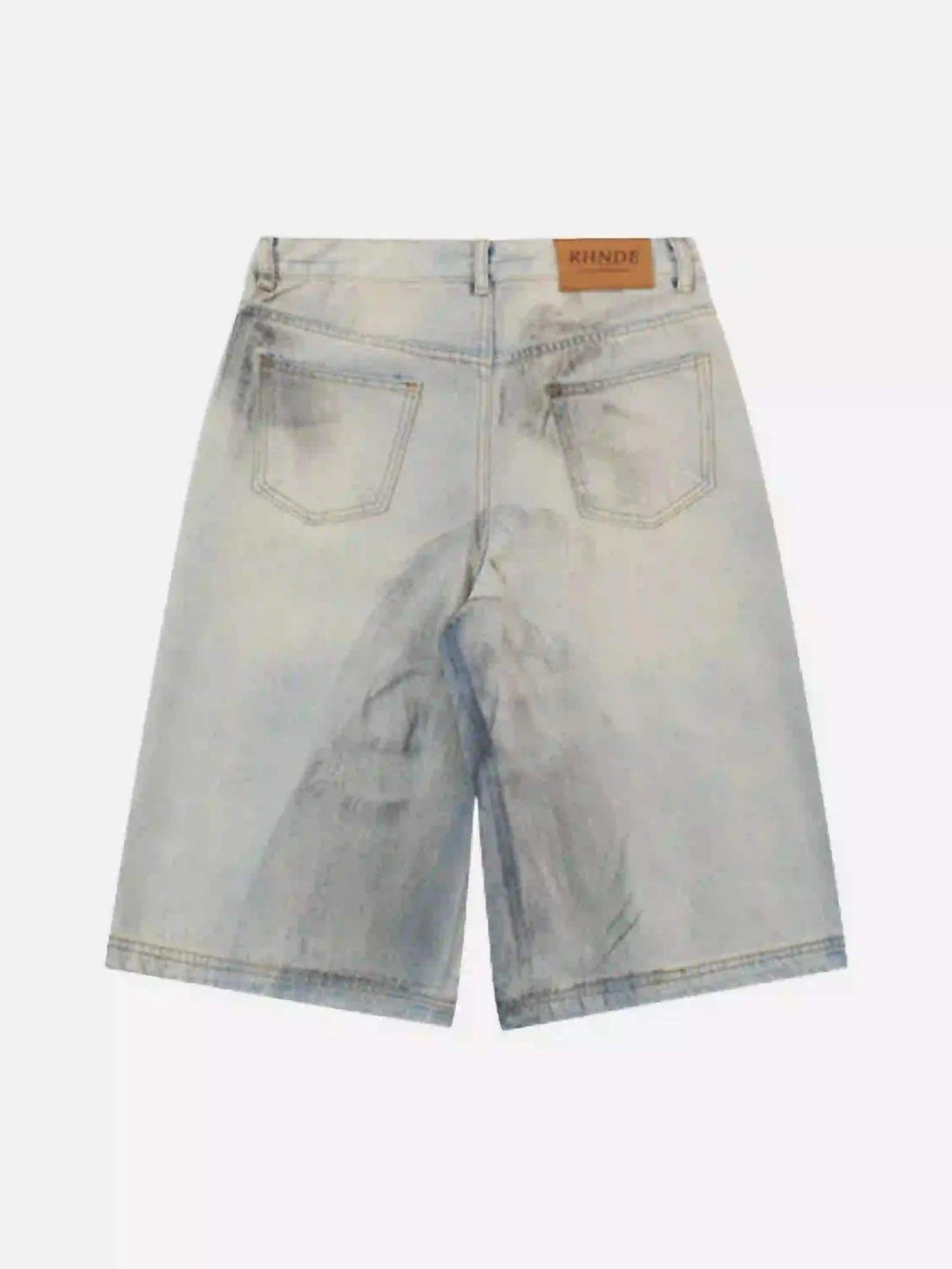 Back view of TALISHKO denim shorts featuring a unique mud-dyed design and label detail.