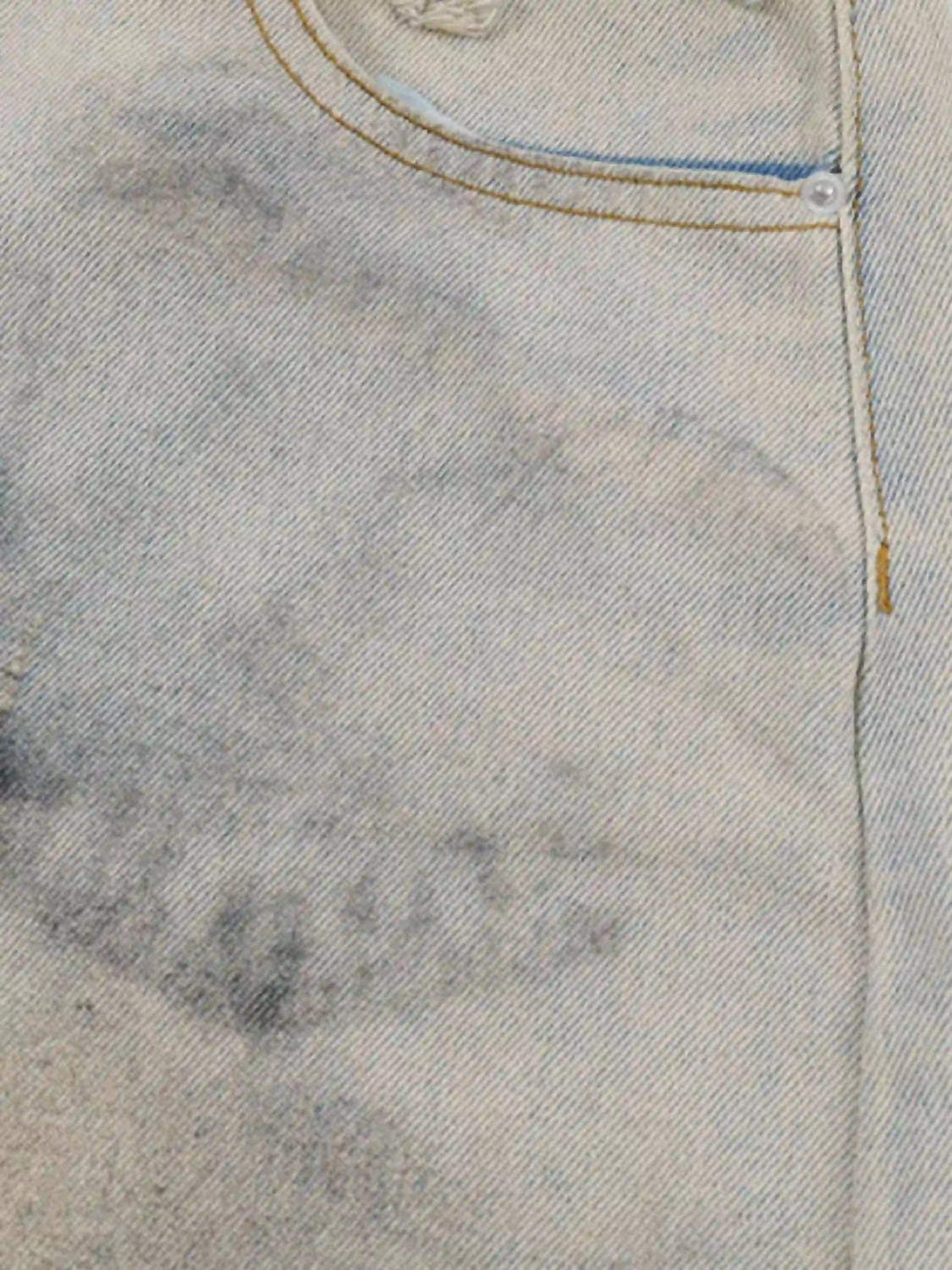 Detailed fabric and stitching of TALISHKO denim shorts, highlighting the unique mud-dyed texture.