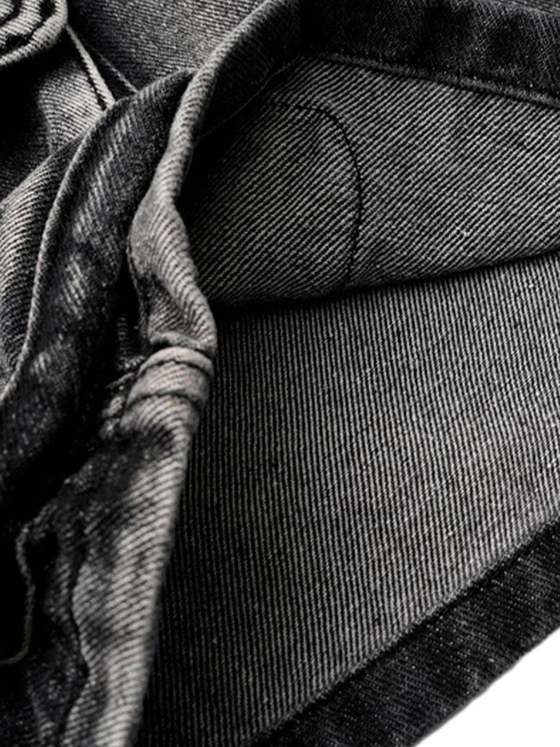 A tight crop highlighting TALISHKO's denim cargo shorts, showcasing detailed fabric texture.