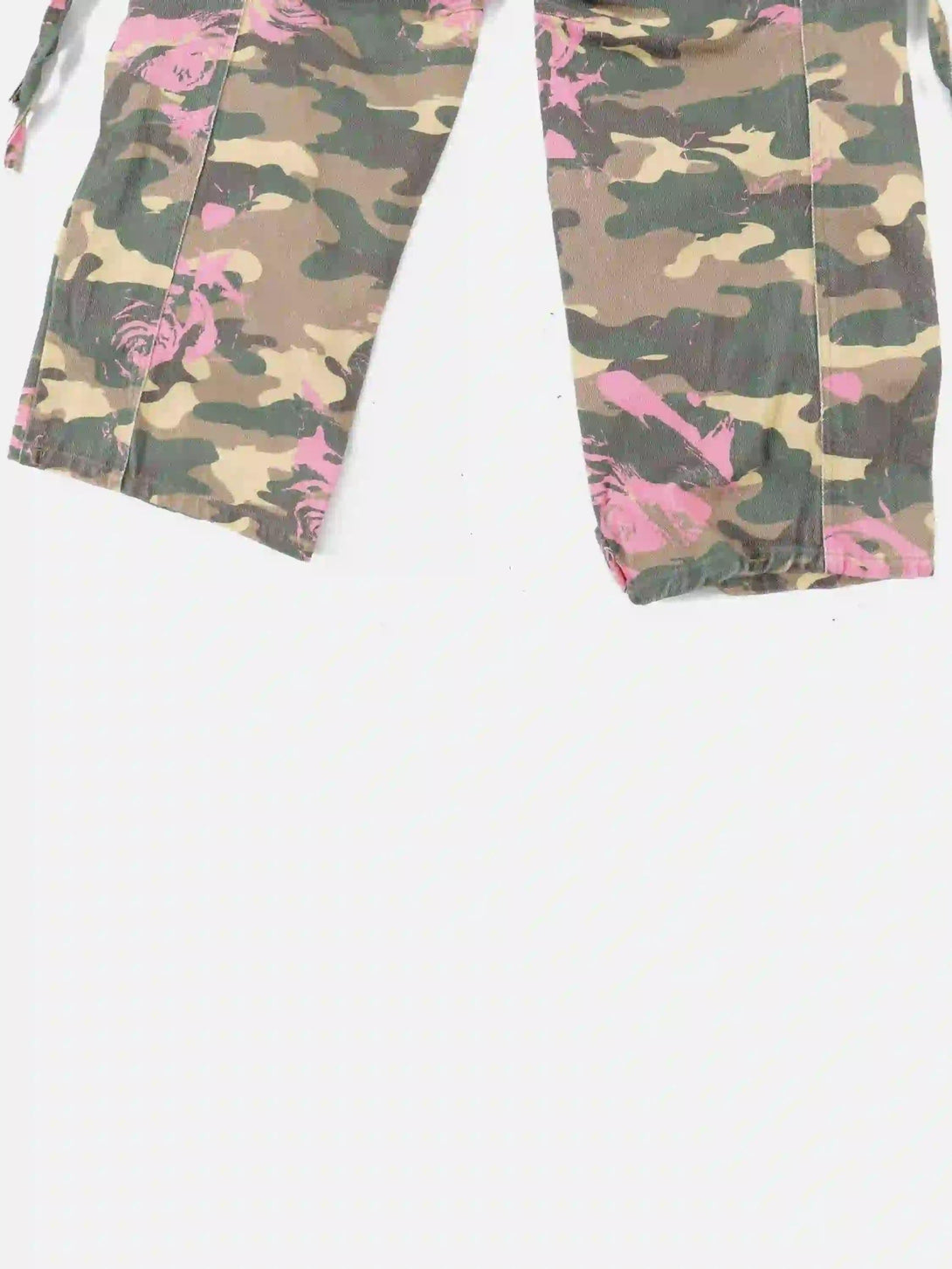 A detailed view of TALISHKO cargo pants, showcasing pink-accented camouflage fabric and pattern.
