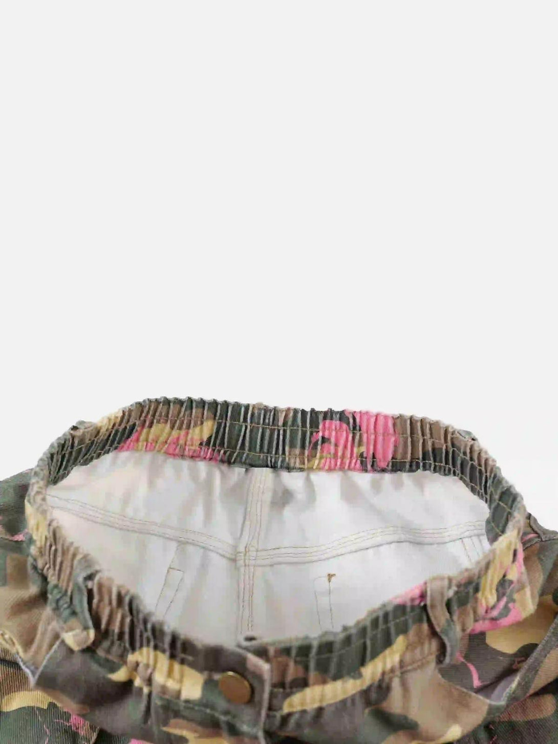 A detailed view of TALISHKO's hip-hop cargo pants waistband, showcasing pink-accented camouflage.