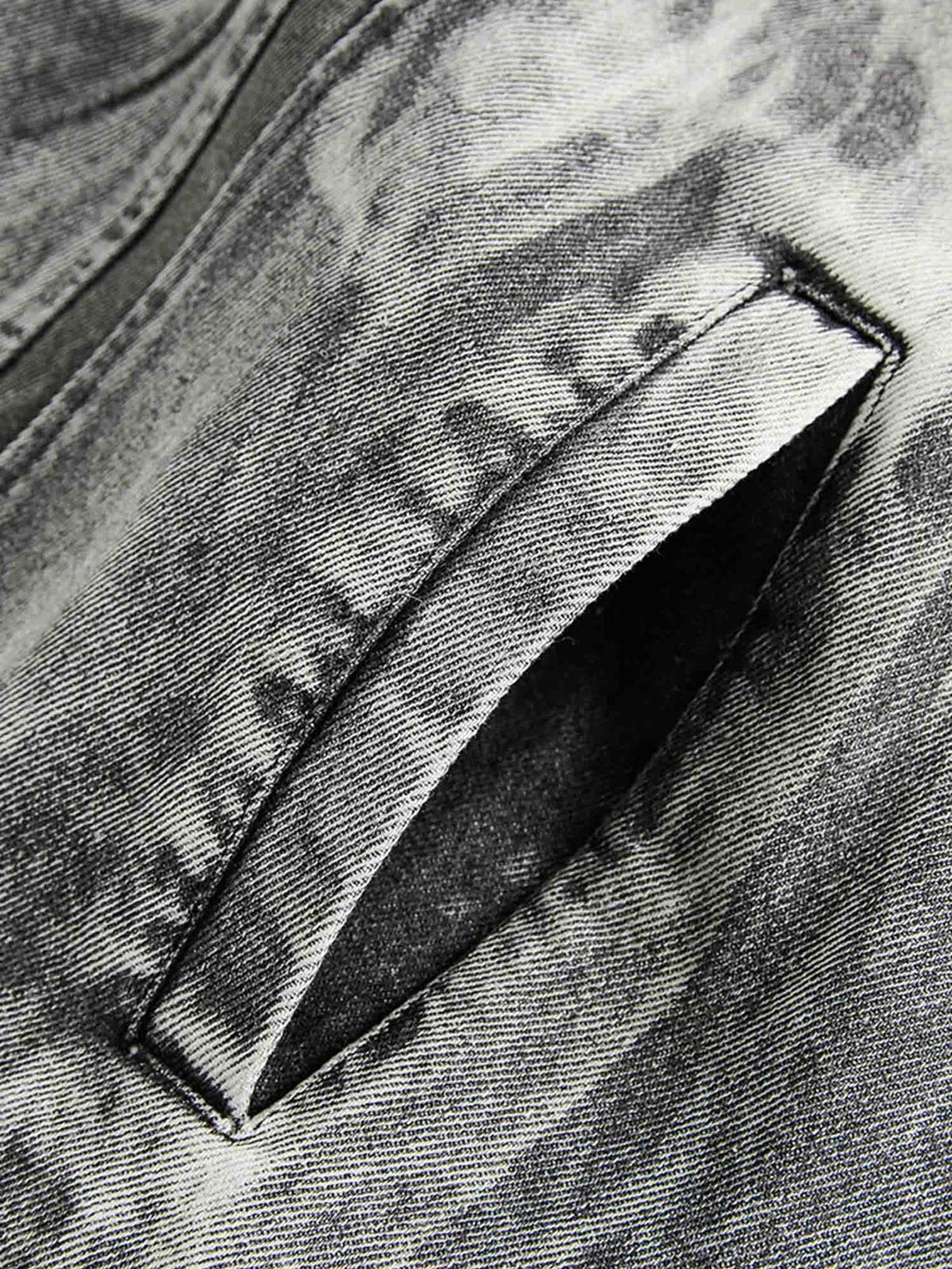 Detailed fabric and stitching on a TALISHKO hip-hop distressed denim jacket.