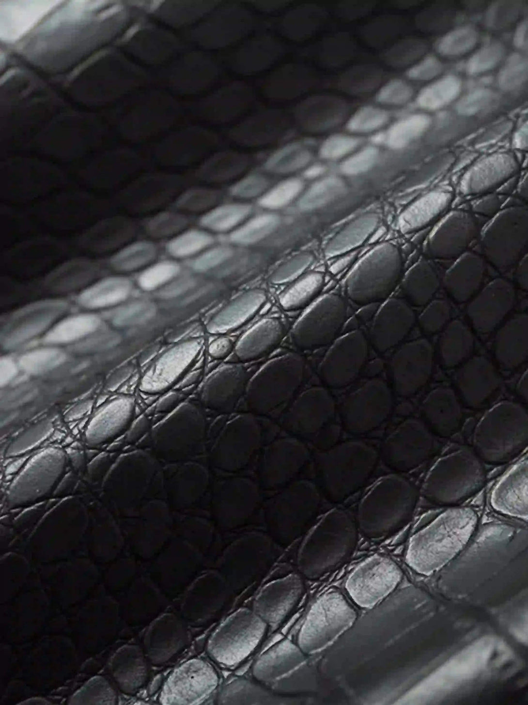 "Texture and pattern showcased on TALISHKO jacket's crocodile-embossed leather detail."