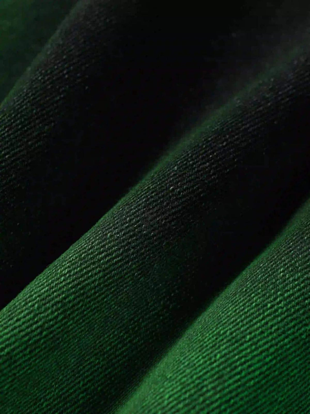 Zoomed-in texture of TALISHKO's green hand-painted jeans, highlighting the fabric detail.