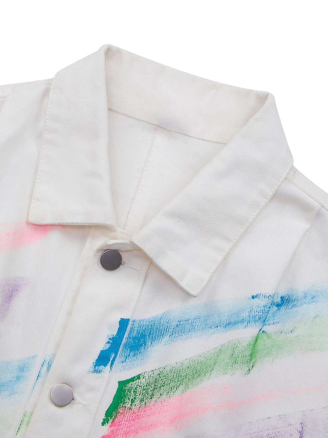 TALISHKO's denim jacket detail with vibrant hand-painted brushstrokes and silver button accents.
