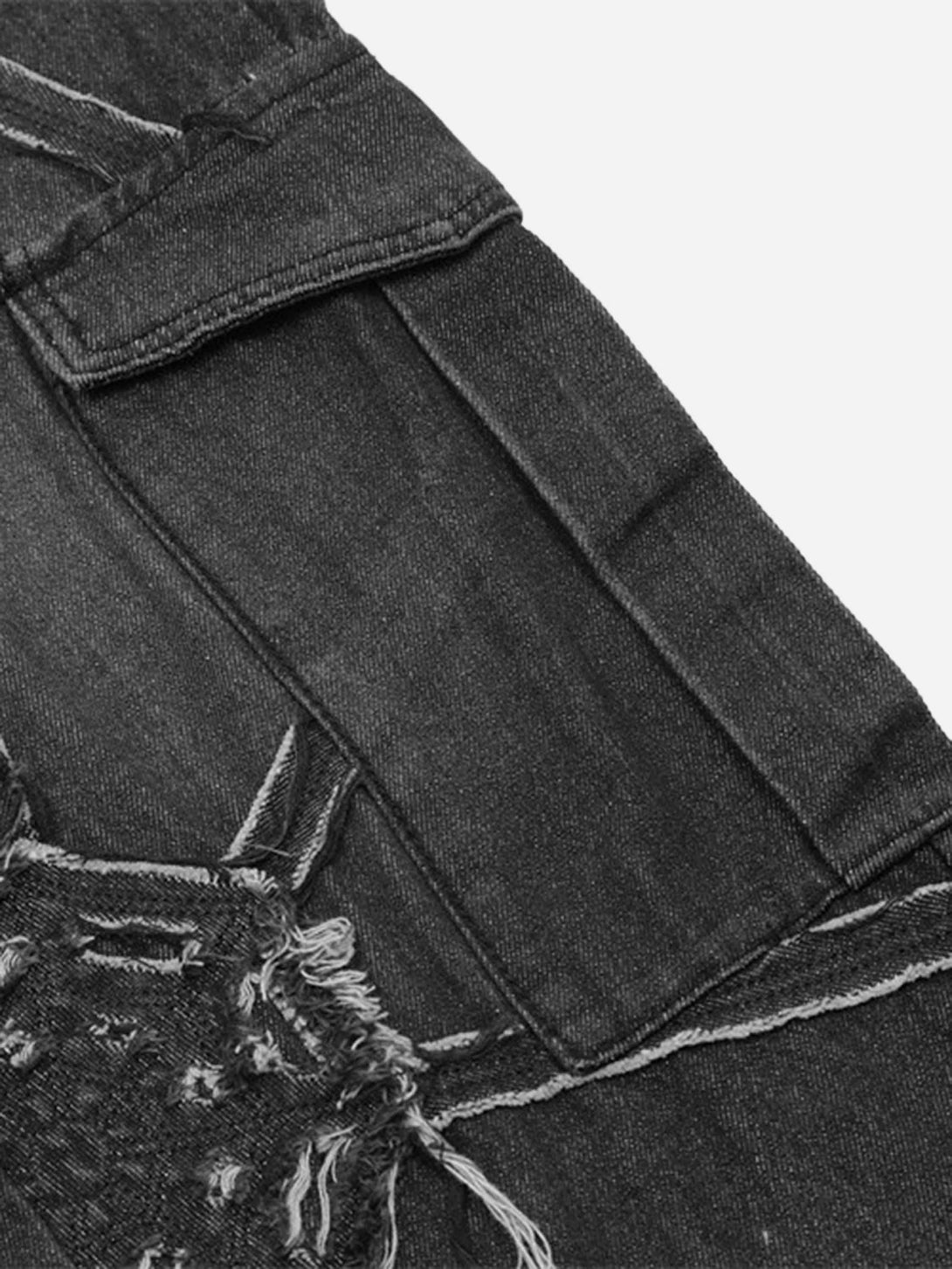 Detailed fabric and stitching on TALISHKO hip-hop jeans, highlighting spider web design.