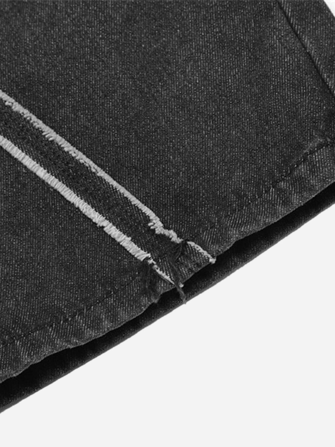 A tight crop highlighting the stitching details on TALISHKO hip-hop jeans with a spider web pattern.