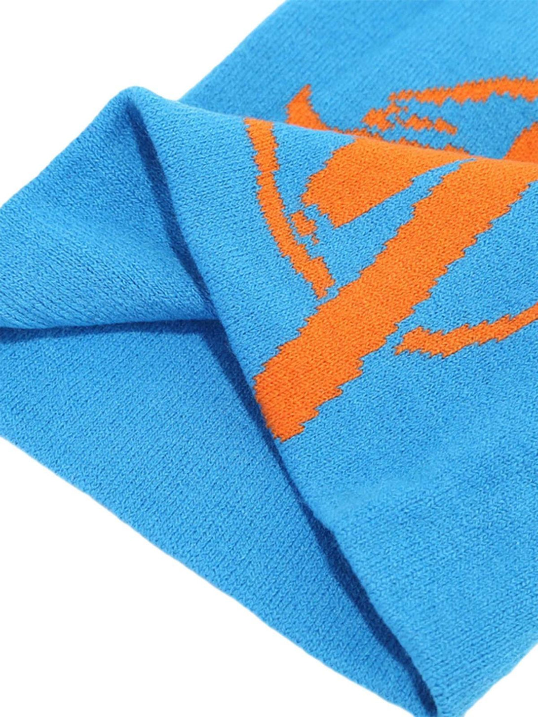 Vibrant orange graphic detail on a blue knit hat by TALISHKO, highlighting hip hop flair.