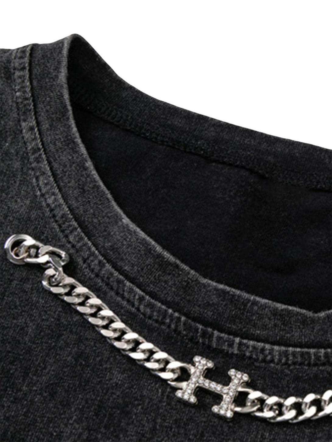 Intricate look at TALISHKO's hip-hop undershirt neckline with chain detail and textured fabric.