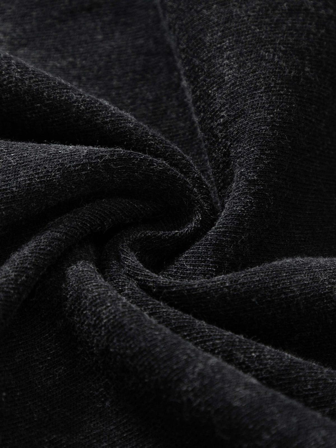 A close-up of the black fabric texture on a TALISHKO hip hop T-shirt, highlighting its quality.