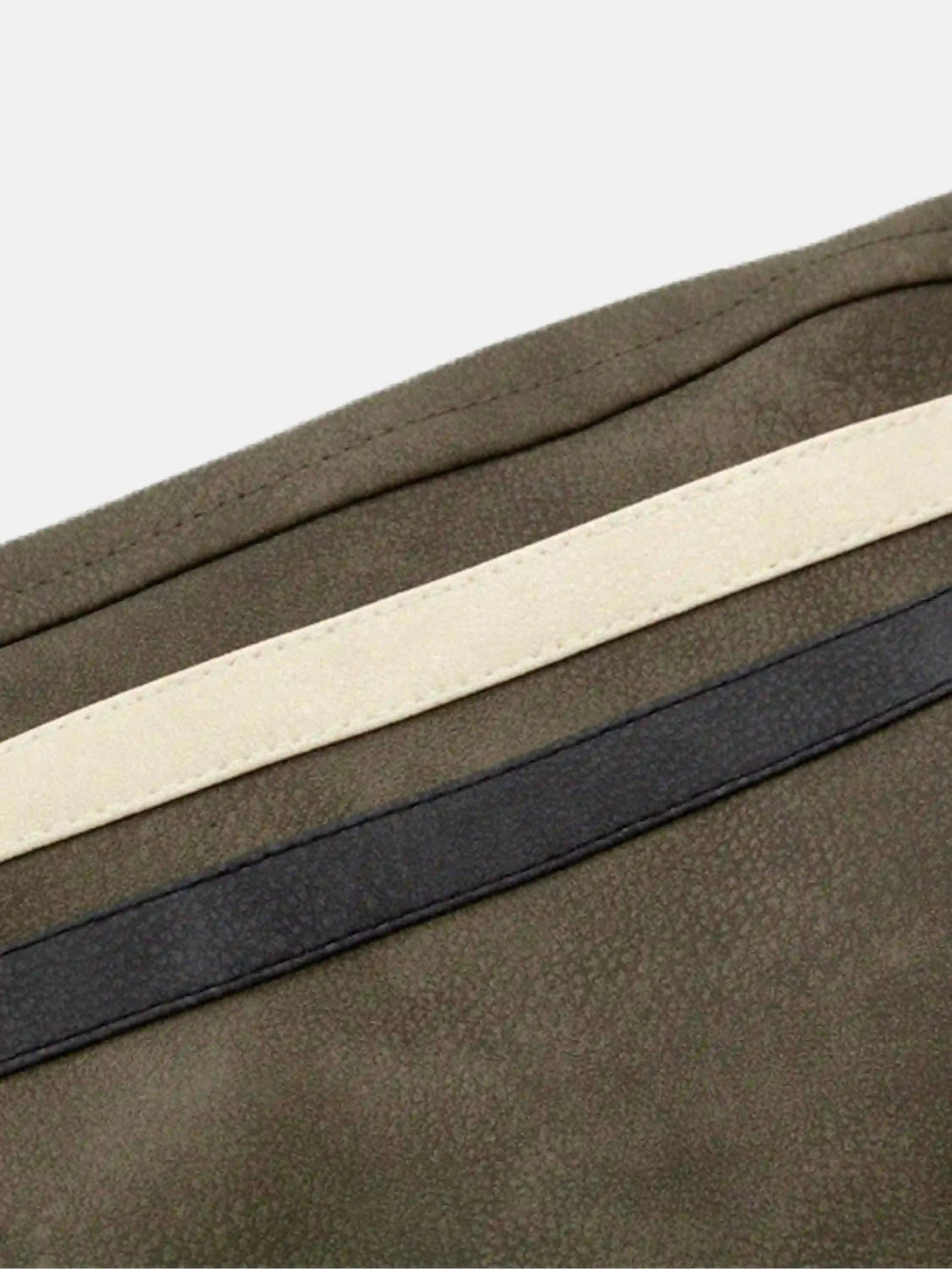 Zoomed-in texture of the hip-hop motorcycle trend jacket by TALISHKO, highlighting stripes.